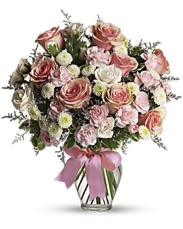Cotton Candy - Sweet as candy! This soft pink and white bouquet is a feminine choice for any occasion. A mix of pink and white flowers including roses, miniature carnations and button spray chrysanthemums is delivered in a spring garden vase adorned with pink ribbon. Orientation: All-Around