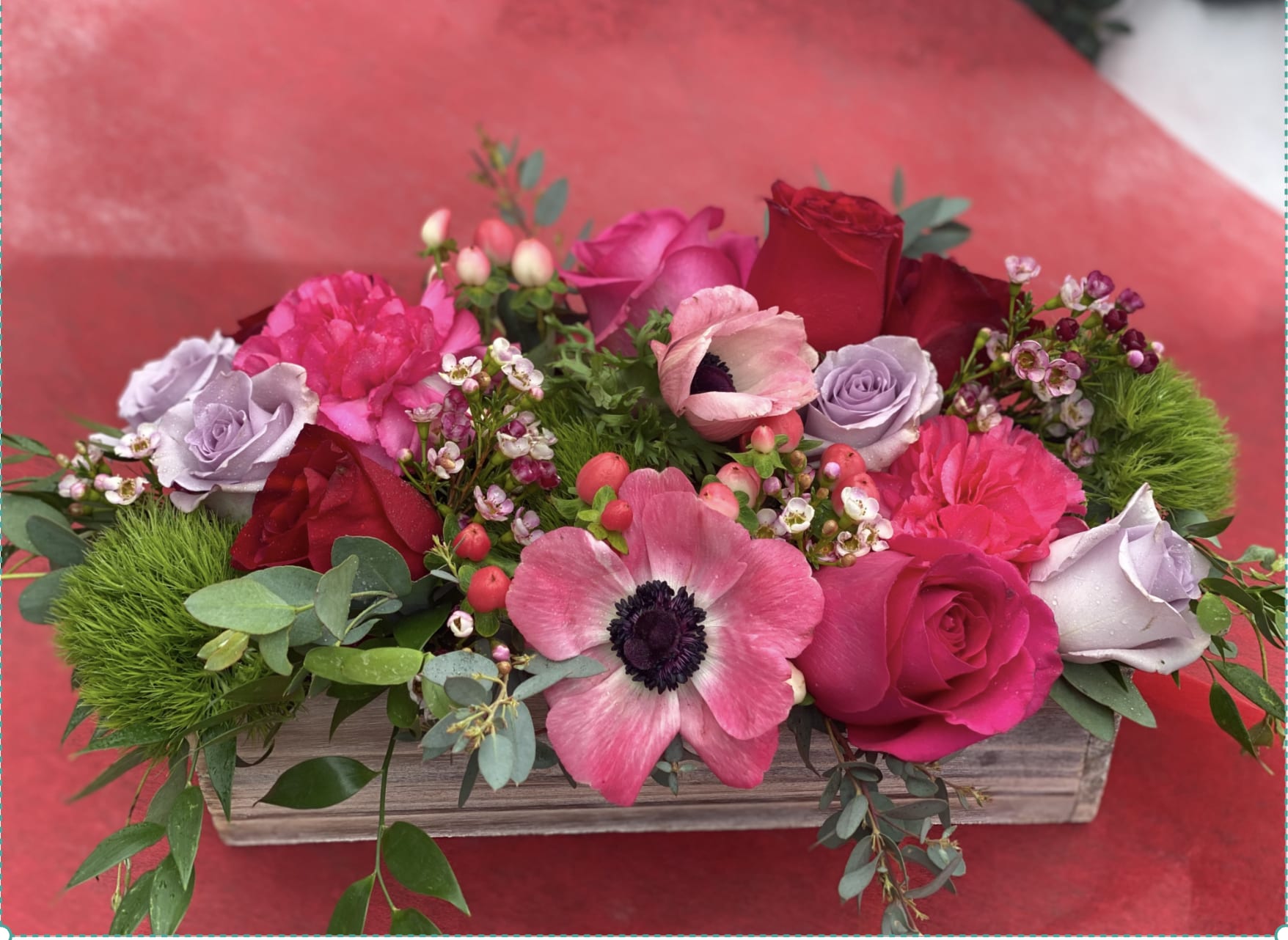 Box of Blooms! - Rectangle harvest boxes are the perfect vessel for flowers createing a lush garden look that can add magic to any room.  Its timeless and a major hit with clients.   These boxes make a gorgeous gift! You can also plant in them after flowers expire- succulents and other small plants look great in these!   Over the winter we will use a nice mix of color in all our boxes.  For Valentine's we use a combination of premium floewers in pinks, reds, lavenders and whites.   Expect a mix of premium florals - anenome, ranunculus, roses, hydrangea, tulips, sweetpeas. We see what looks best at the market.     Standard=  Rectangle Pine - 10"x 4.5 " W x 4.5 " D- we design the flowers well exceeded vessel size- expect florals to be approx 14" in length Deluxe = a rectangle longer box that is 14"L x 5" W- we use even more flowers and its spectacular!  UPGRADE TO PLATED GLASS.  Plated glass vessel approx 17"L x 3" W- It is a stunner &amp; you will keep it forever.   