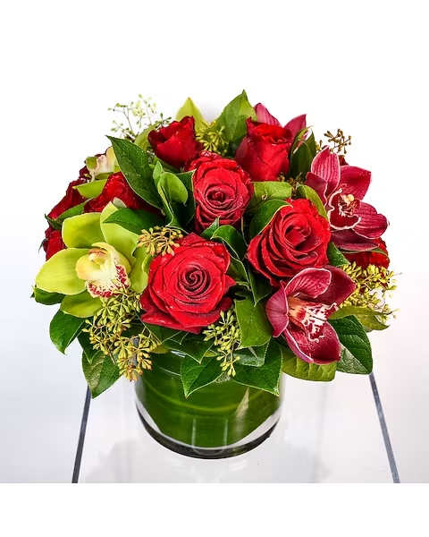 Red Empress - A dozen red roses with elegant cymbidium orchid blooms. Half of the bouquet has green orchid accents, and the other half has burgundy cymbidium orchids.