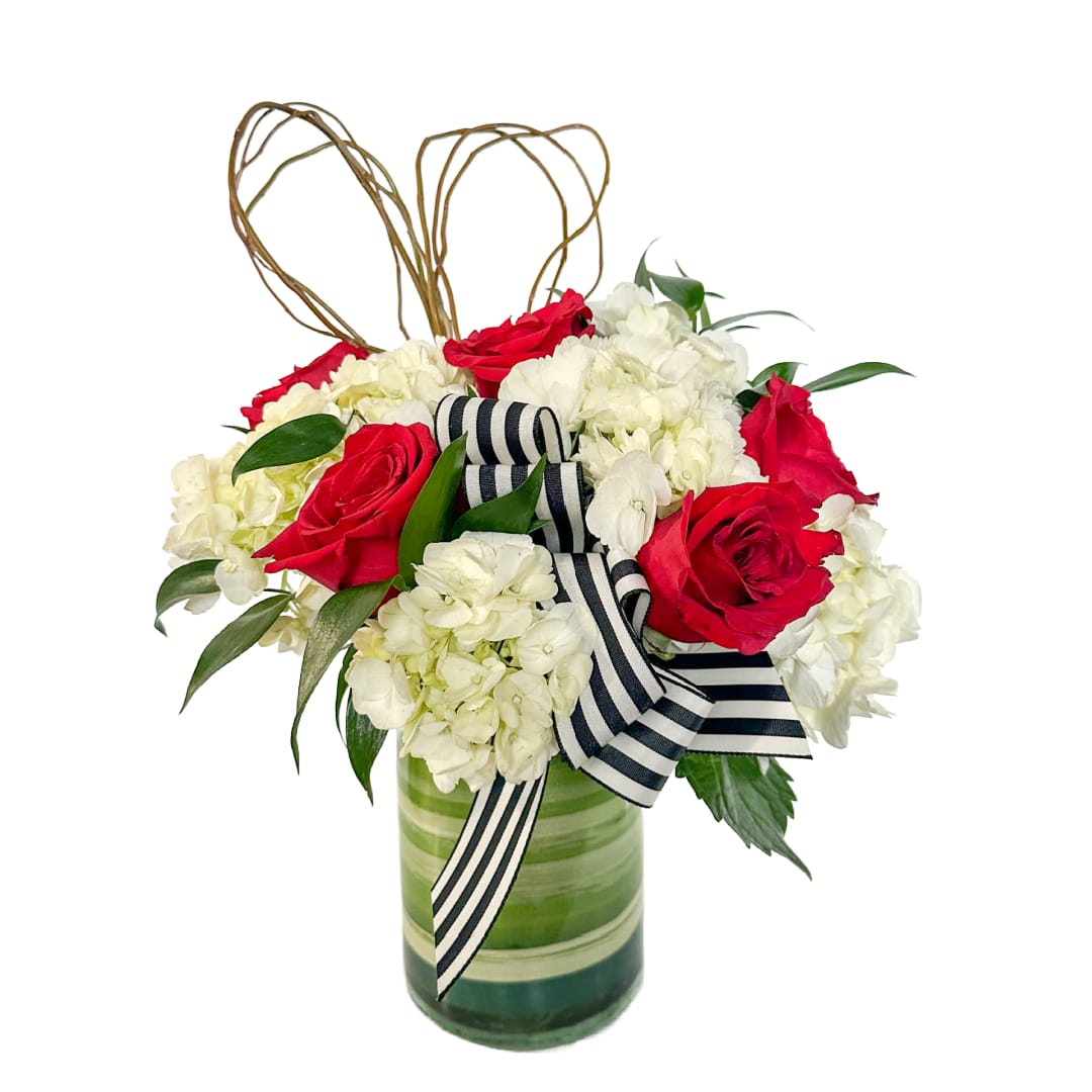 Modern Love - Modern Love is a striking and contemporary arrangement featuring classic red roses nestled among lush white hydrangea and fresh greenery. Designed in a modern glass cylinder accented with a bold black-and-white ribbon and a sculptural heart detail, this arrangement offers a stylish way to celebrate love, anniversaries, or meaningful moments.