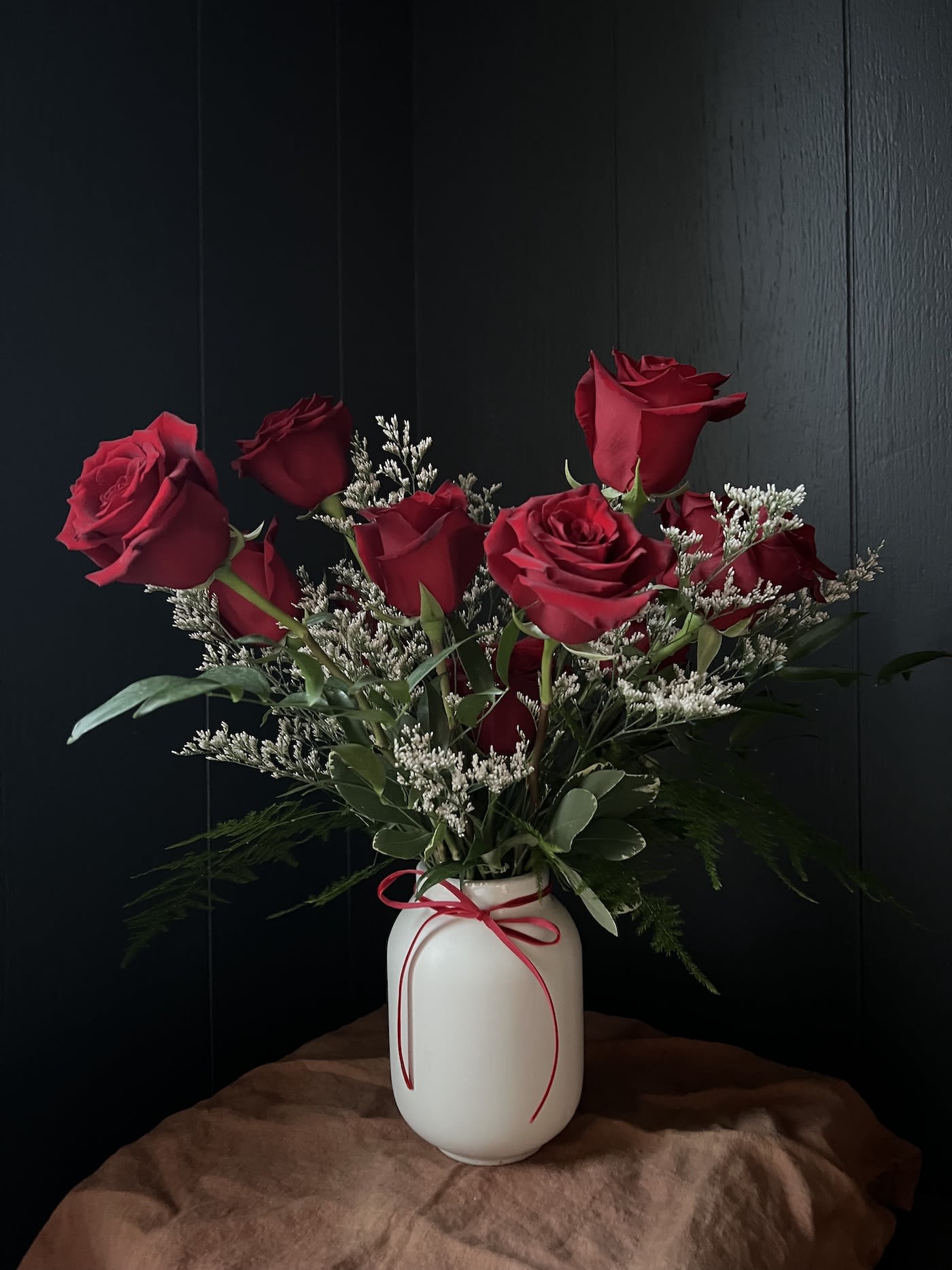 VALENTINE'S DAY PRE-ORDER: RED ROSES - Twelve red roses beautifully arranged in a white ceramic vase.   Available for delivery or pick up at Morristown shop Wedesday 2/11, Thursday 2/12, Friday 2/13 and Saturday 2/14.