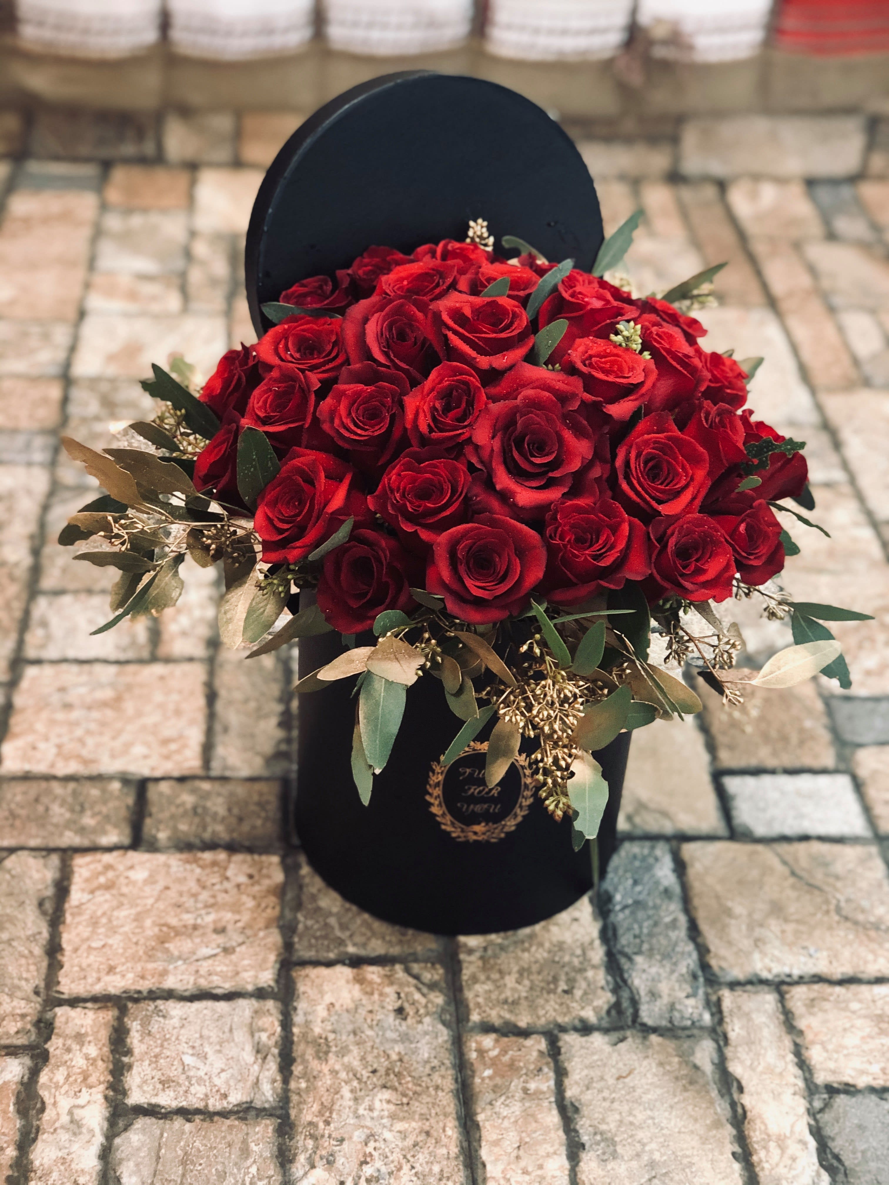 Large Rose Box - Classic red roses arranged in a classy gift box, adorned with tulle and assorted greenery. Our lavish rose boxes will leave your sweetheart speechless. Alternate rose colors available, contact us to make a custom color choice. 