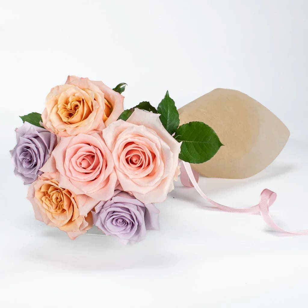 Six Assorted Roses Wrapped - Six gorgeous roses in assorted colours designed with either basic greenery or fancy filler and wrapped in tissue and cellophane.