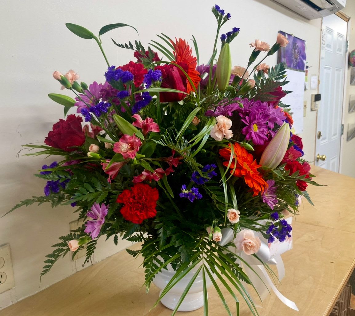 Spring Morning by Lotherington's - This colorful funeral arrangement is representative of a life lived to its fullest. Fitting for any type of service, colors and flowers may change based off of season and availability. 