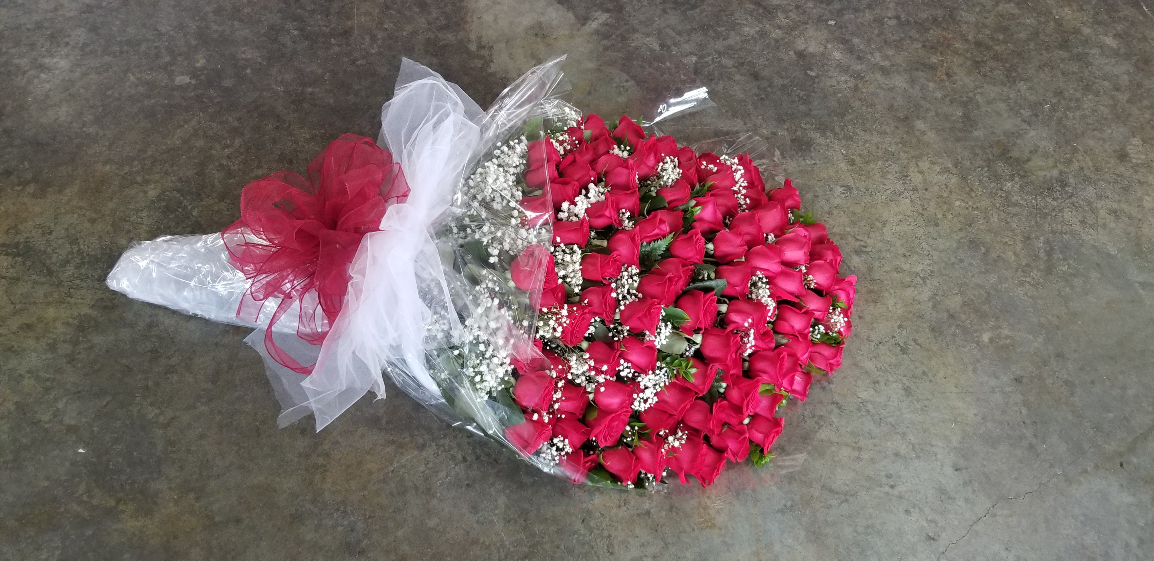 Forever! Roses - Wow them with this big and beautiful bouquet of 99 long stemmed red roses wrapped in cellophane with greenery and filler. 