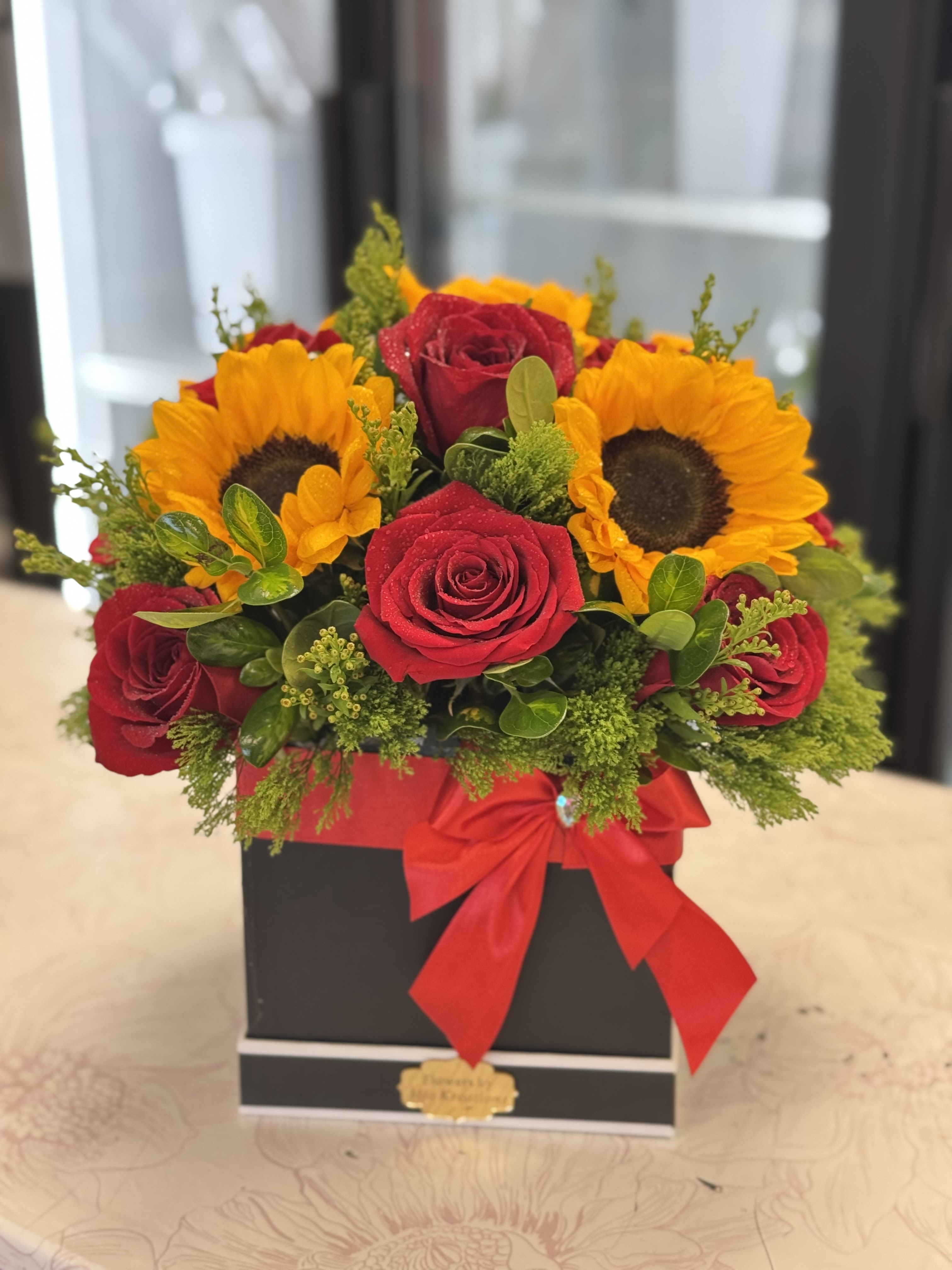 SQUARE BOX SUNFLOWERS AND ROSES - BEAUTIFUL SQUARE BOX, BLACK OR WHITE, GREENERY, SUNFLOWERS AND ROSES FOR THIS SPECIAL OCASSION.