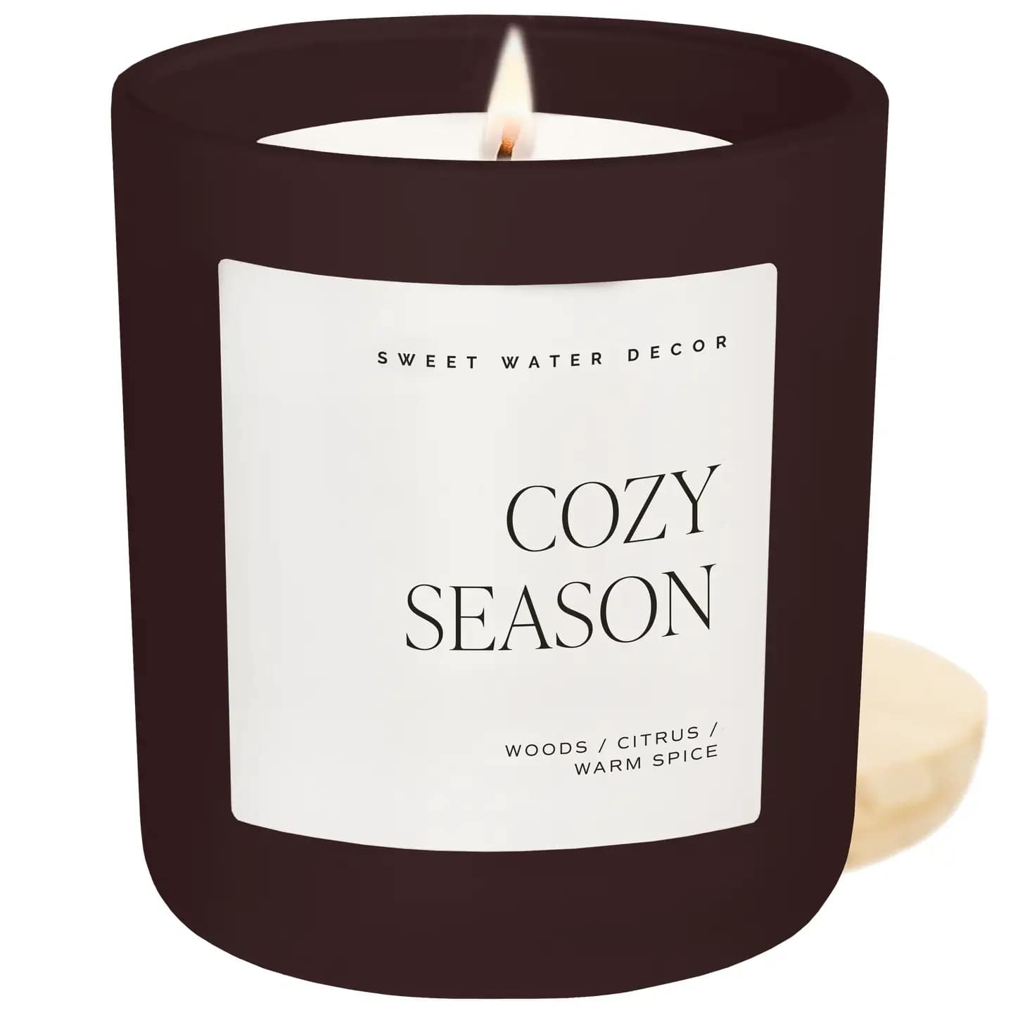 Cozy Season 15 oz Candle, Matte Jar -  - Cozy Season is the perfect transitional scent to carry them from the first crisp days of Fall through Halloween, Thanksgiving, Christmas, and into the heart of Winter.  With rich notes of woods, warm spice, and citrus, this inviting fragrance captures the essence of cozy nights by the fire and quiet holiday mornings. Whether they’re decorating for Autumn, hosting a Thanksgiving dinner, or curling up after a day in the snow, your customers will want to light Cozy Season again and again.  SCENT NOTES: • Top: Woods • Middle: Warm Spice • Base: Citrus