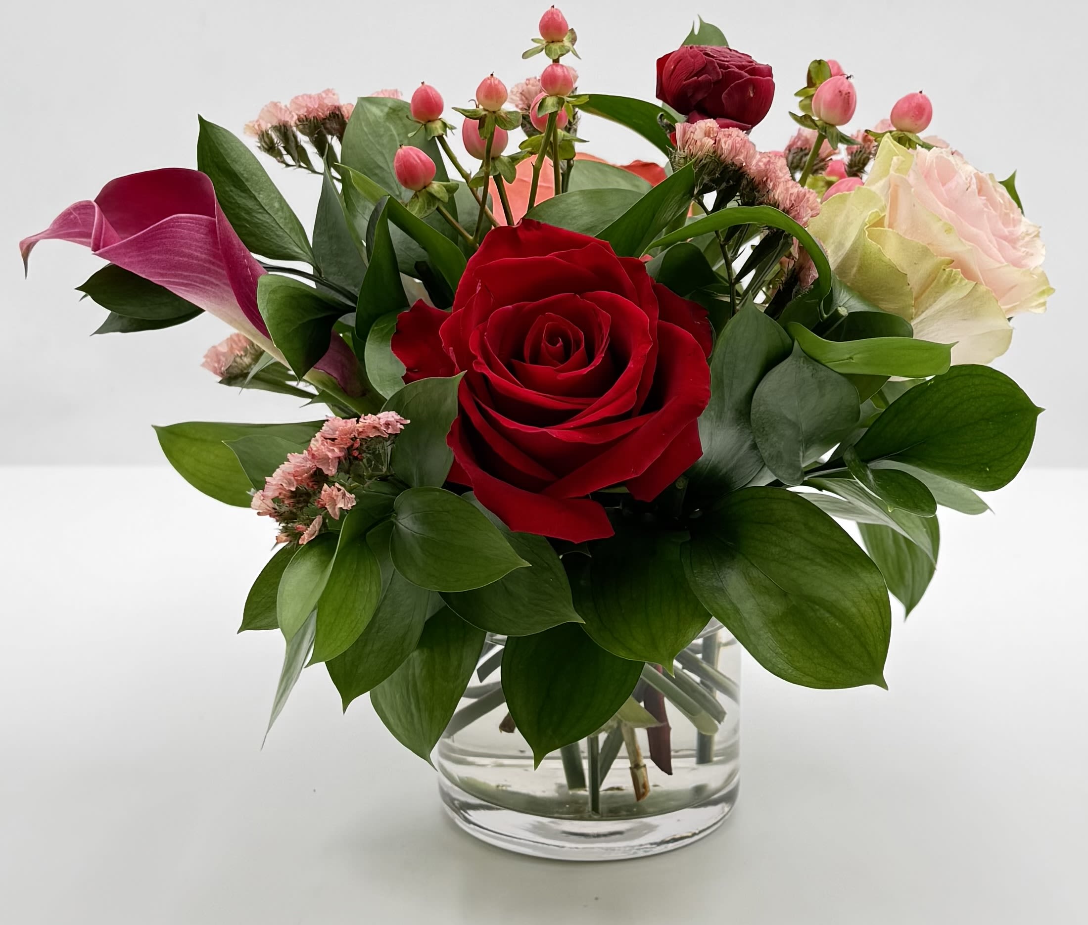 A Lil Sweetness - A lil sweetness goes a long way. Roses, cala lily, and more in this thoughtful arrangement. A scaled down arrangement with the same care and quality of our larger designs.