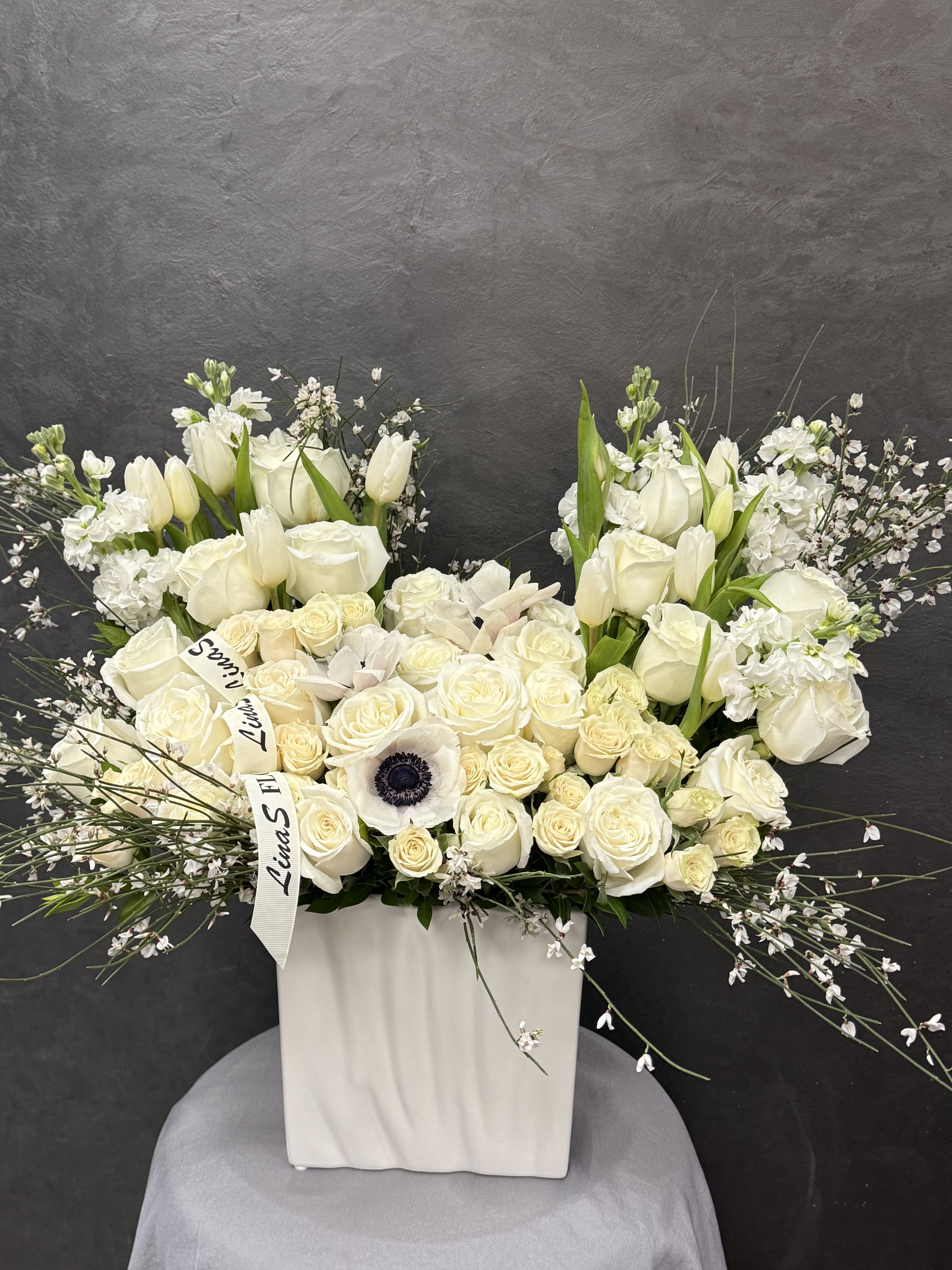 Lola white - White roses and anemones — a pure expression of elegance and timeless beauty.
