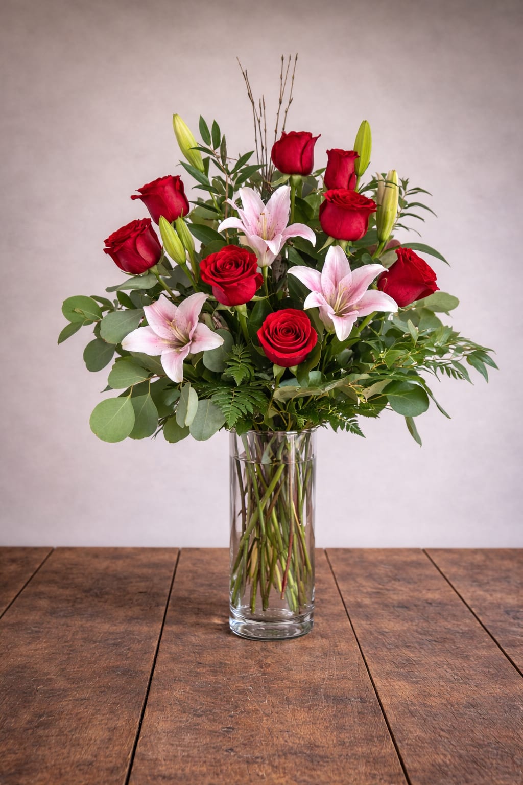 Roses and Lilies - A unique arrangement hand-created by our experienced designers. Please note that every design is custom made and substitution to container and flower types may happen from time to time. Design aspects will always stay the same, but if needed, we will substitute with flowers of equal or greater value to offer you a great floral shopping experience! Our flowers are 100% guaranteed. Please call us with any questions or concerns