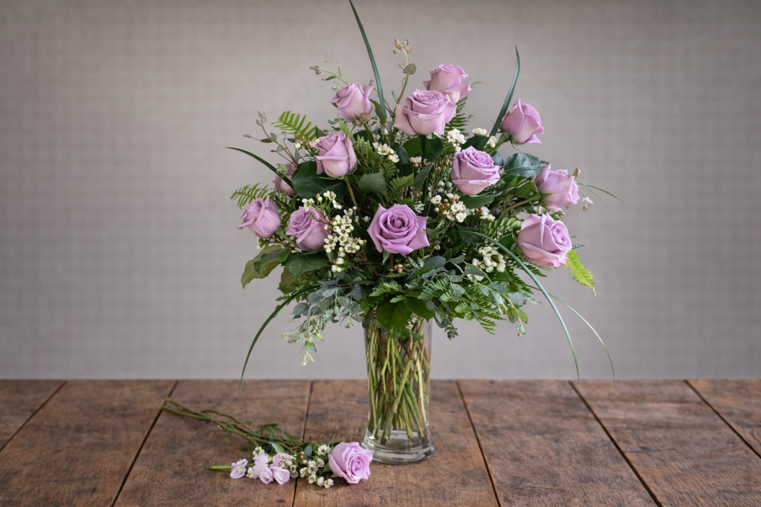 One Dozen Lavender Roses  - A dozen stunning Lavender Roses. The best gesture of love! Everyone deserves these love stems for any special day!1 Dozen beautiful Lavender Roses professionally designed with soft fillers and lush greens for a perfect presentation!  A unique arrangement hand created by our experienced designers. Please note that every design is custom made and substitution to container and flower types may happen from time to time. Design aspects will always stay the same, but if needed, we will substitute with flowers of equal or greater value to offer you a great floral shopping experience! Our flowers are 100% guaranteed. Please call us with any questions or concerns.