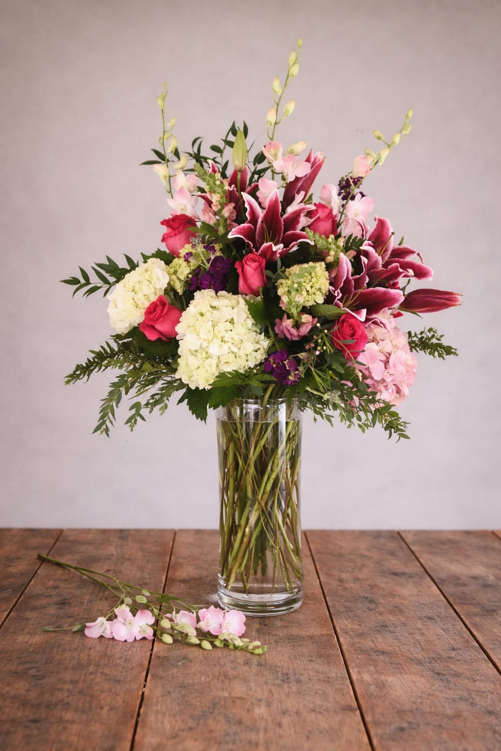 TGI-Flowers  - This elegant vase is filled with a beautiful combination of pink and white flowers, creating a lovely and harmonious display. Perfect as a centerpiece for any room or as a thoughtful gift for a special occasion, this arrangement adds a touch of sophistication and charm to any space. The vibrant colors and delicate blooms are sure to brighten up any environment and bring a sense of joy and beauty to those who admire it.  A unique arrangement hand created by our experienced designers. Please note that every design is custom made and substitution to container and flower types may happen from time to time. Design aspects will always stay the same, but if needed, we will substitute with flowers of equal or greater value to offer you a great floral shopping experience! Our flowers are 100% guaranteed. Please call us with any questions or concerns.