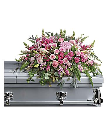 Beautiful Memories Casket Spray - Like your beautiful memories, this dramatic spray of pink hydrangea, roses and lilies will take your breath away. A fresh, feminine symbol of hope for the service. This dramatic spray features pink hydrangea, pink roses, pink spray roses, pink stargazer lilies, pink carnations, pink larkspur, pink snapdragons, pink stock, green ivy, sword fern, silver dollar eucalyptus, seeded eucalyptus, and lemon leaf. Approximately 41" W x 27" H