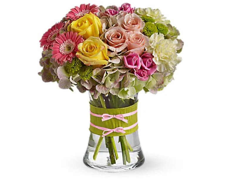Fashionista Blooms - This arrangement would be perfect for any girl with an eye for style. It's a must-have for fashionistas everywhere. Gorgeous green hydrangea, yellow and light pink roses, pink spray roses and mini gerberas, light yellow carnations and green button spray chrysanthemums are delivered in a pretty gathering vase. Not just any vase, of course, this one's accessorized with a chartreuse taffeta ribbon and pink raffia.   Orientation : All-Around  All prices in USD ($)  Standard  T155-1A  Deluxe  T155-1B  Premium  T155-1C