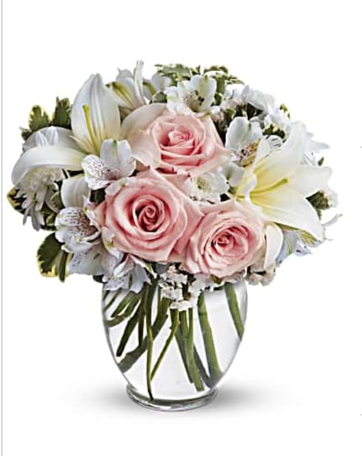 Arrive style - Express your love with the eloquence of Shakespeare - without saying a word. She'll adore this exquisite bouquet of roses and lilies and other pastel favorites in a classic ginger vase. And she'll know just the words to let you know. Light pink roses, white asiatic lilies, white alstroemeria and white cushion spray chrysanthemums are mixed with white statice and variegated pittosporum in a clear, rounded vase. Orientation: All-Around  SUBSTITUTION POLICY – Always deliver the freshest flowers! Please note the bouquet pictured reflects our original design.  If the exact flowers or container in this arrangement are not available, our local florists will create a beautiful bouquet with the freshest available flowers.