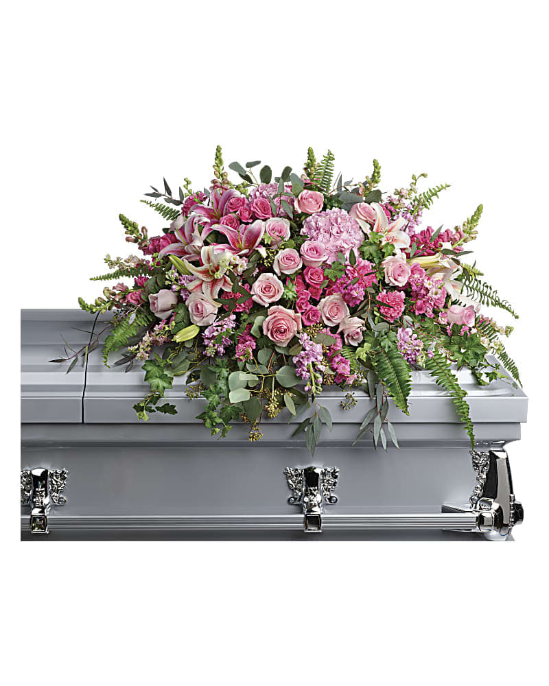 Beautiful Memories Casket Spray - Like your beautiful memories this dramatic spray of pink hydrangea roses and lilies will take your breath away. A fresh feminine symbol of hope for the service. This dramatic spray features pink hydrangea pink roses pink spray roses pink stargazer lilies pink carnations pink larkspur pink snapdragons pink stock green ivy sword fern silver dollar eucalyptus seeded eucalyptus and lemon leaf.