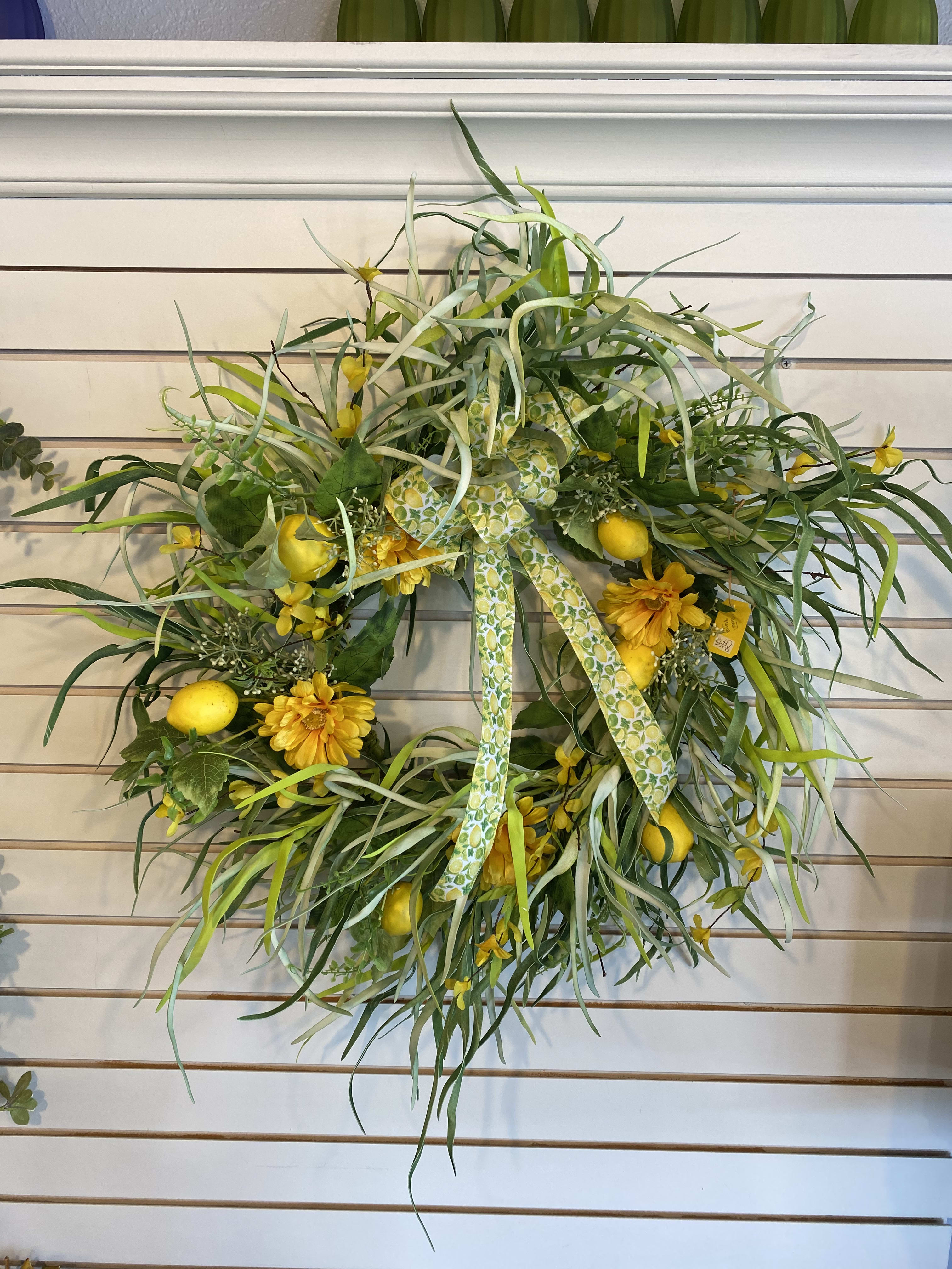 Lemon Wall Wreath - A super cute artificial wreath, accented with some artificial lemons. This wreath is about 2 feet wide. 