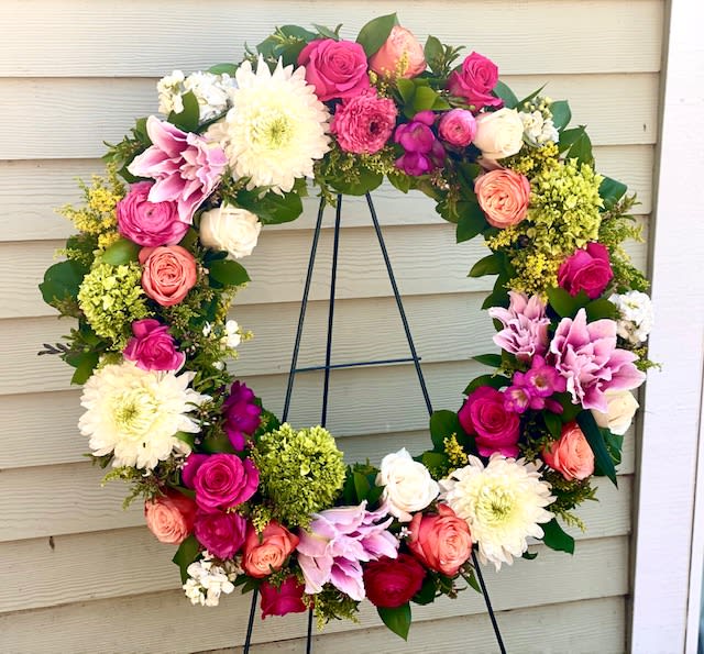 Circle Of Life Wreath - Seasonal blooms in your color palate. Pictured is Dahlias,lilies, hydrangea, ranunculus, Roses and greens. Premium is a 36" Standard is 24" (measurement is from one side to the other of the frame only)