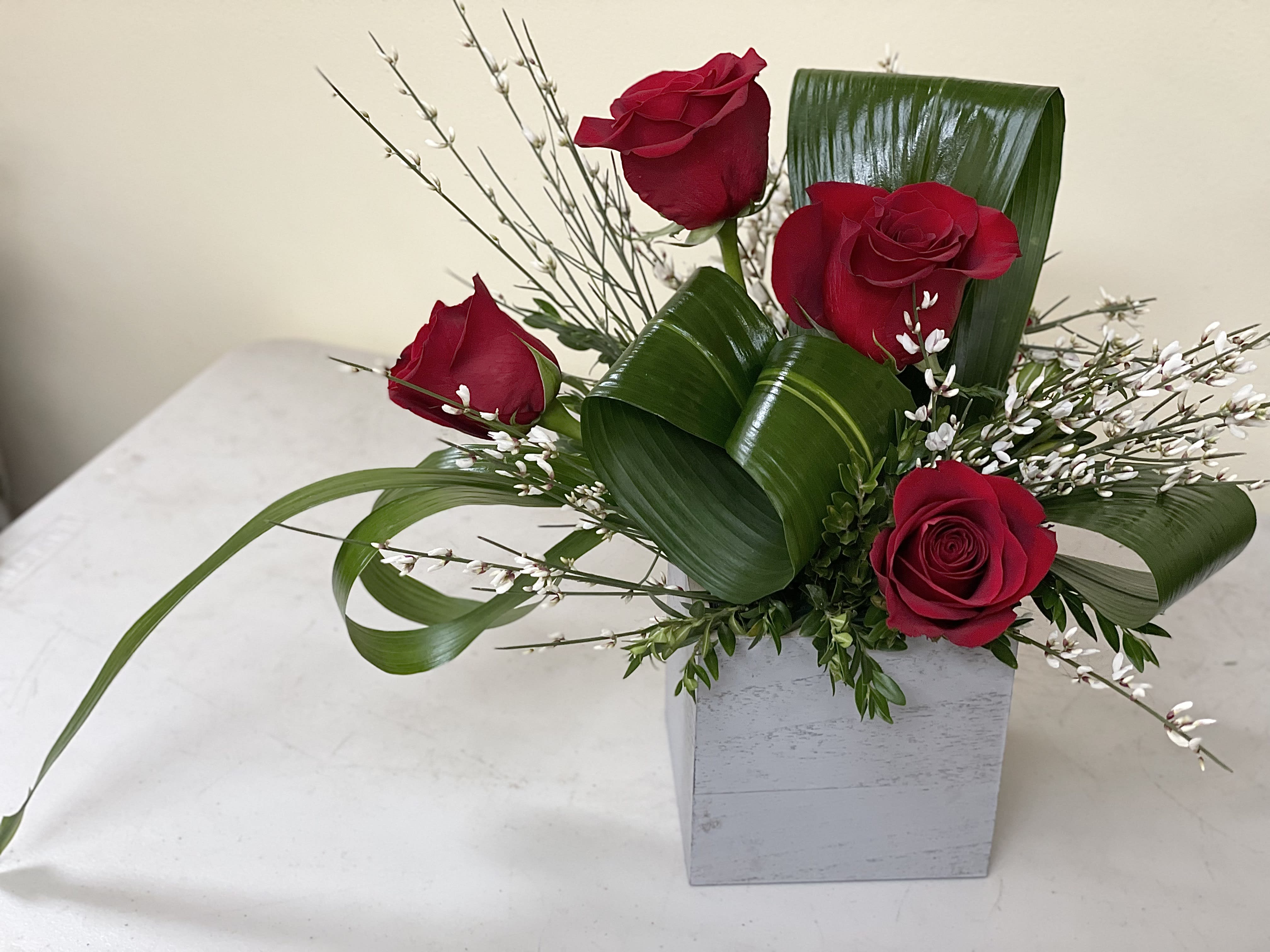 Modern Love - A modern, tropical designed floral arrangement for that really special person in your life, red roses of course and lush greens.