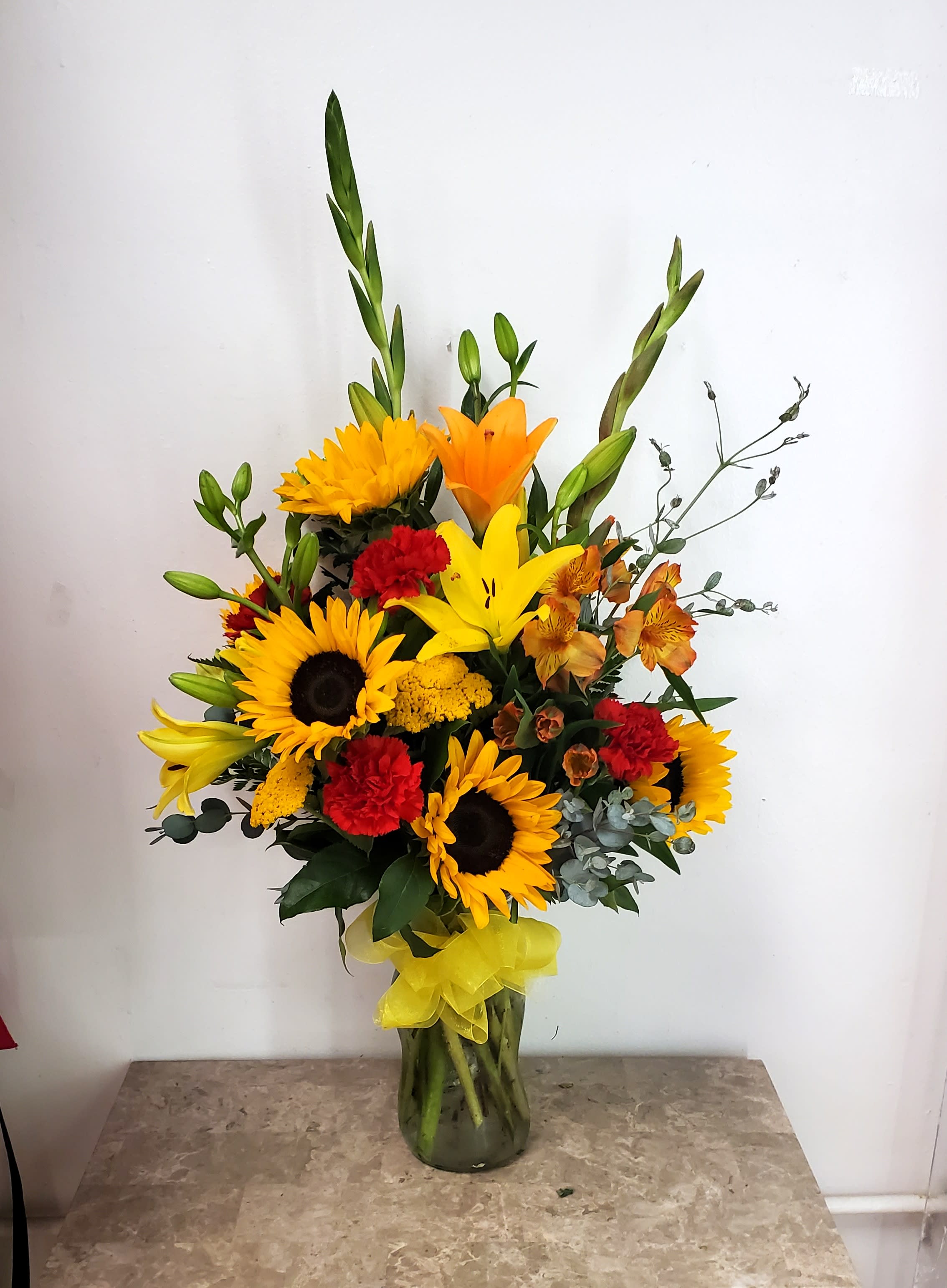 Autumn 1 - Disclaimer IF WE HAVE TO SUBSITUTE:  For flowers, we will make every attempt to match the flower type / color but may substitute with another color or type of flower. For green and blooming plants, similar plants may be substituted of equal or greater value. If the container / vase shown online is not available, a similar container / vase will be used. Bears or other gift items may be substituted as well. Want to check on availability? If it makes you feel more comfortable about the purchase, then we encourage you to call or email us to check on the latest availability of certain products. We would be glad to give you the most current, up-to-date status on our inventory. Deluxe - Additional flowers will be added to enhance the bouquet. Premium - We will add more blooms and select the highest quality flowers we offer in this style.