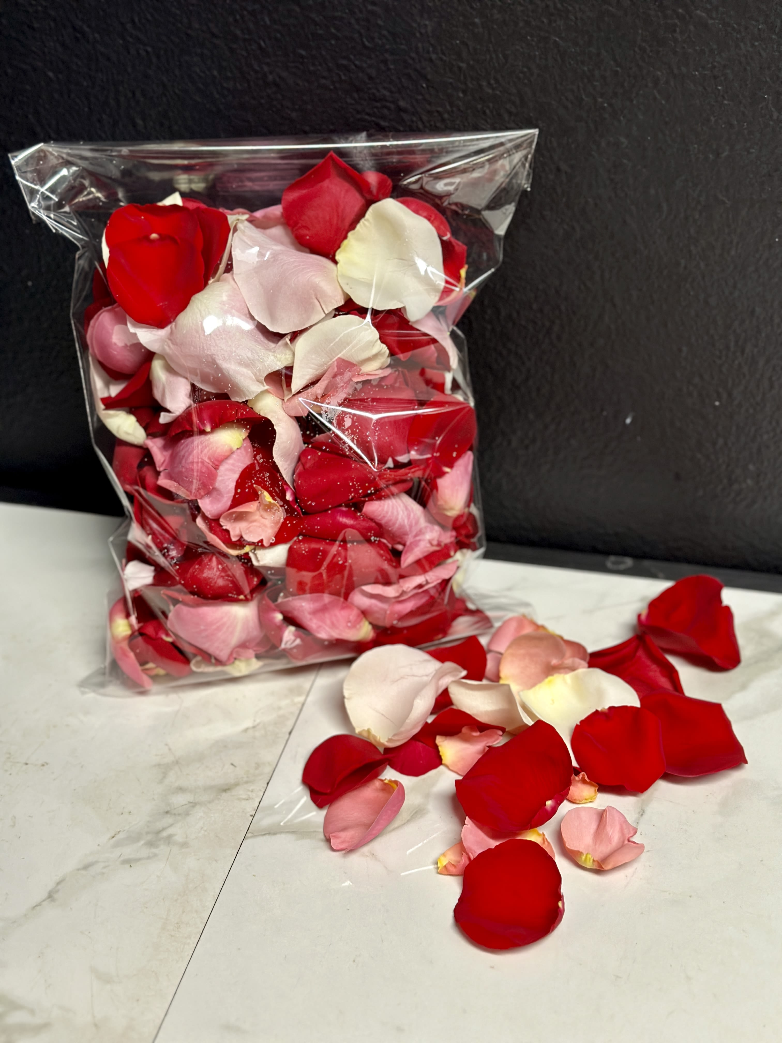 Rose Petals- Romantic Confetti  - A small bag of mixed romantic colored rose petals. Usually a mix of Red, Pink, &amp; White, colors may vary with weekly availability.  Bag is approximately 8.5" x 11" x 1". 