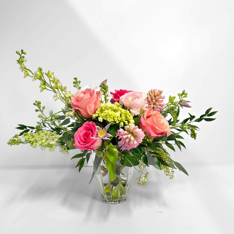 Bisou Bisou - A charming, whimsical garden arrangement that blends soft pinks and fresh greens in a delicate, spring-inspired bouquet. 