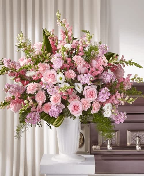Divine Comfort Arrangement -  The gift of flowers often shares a message of sympathy that words cannot express. For sending condolences that are truly from the heart, our Divine Comfort Arrangement beautifully captures your sentiment. It is elegantly crafted with lisianthus, roses, stock and snapdragons. 