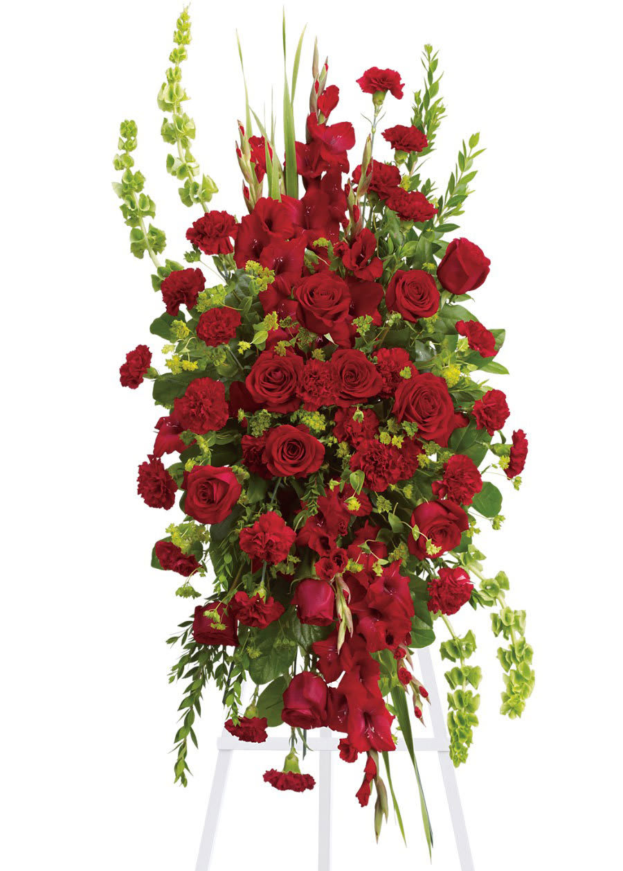 Care &amp; Compassion Standing Spray - This elegant, all red funeral spray conveys compassion and deep devotion. Presented on a traditional easel, it features a beautiful array of red funeral flowers accented with unique bells of Ireland and other graceful greens.