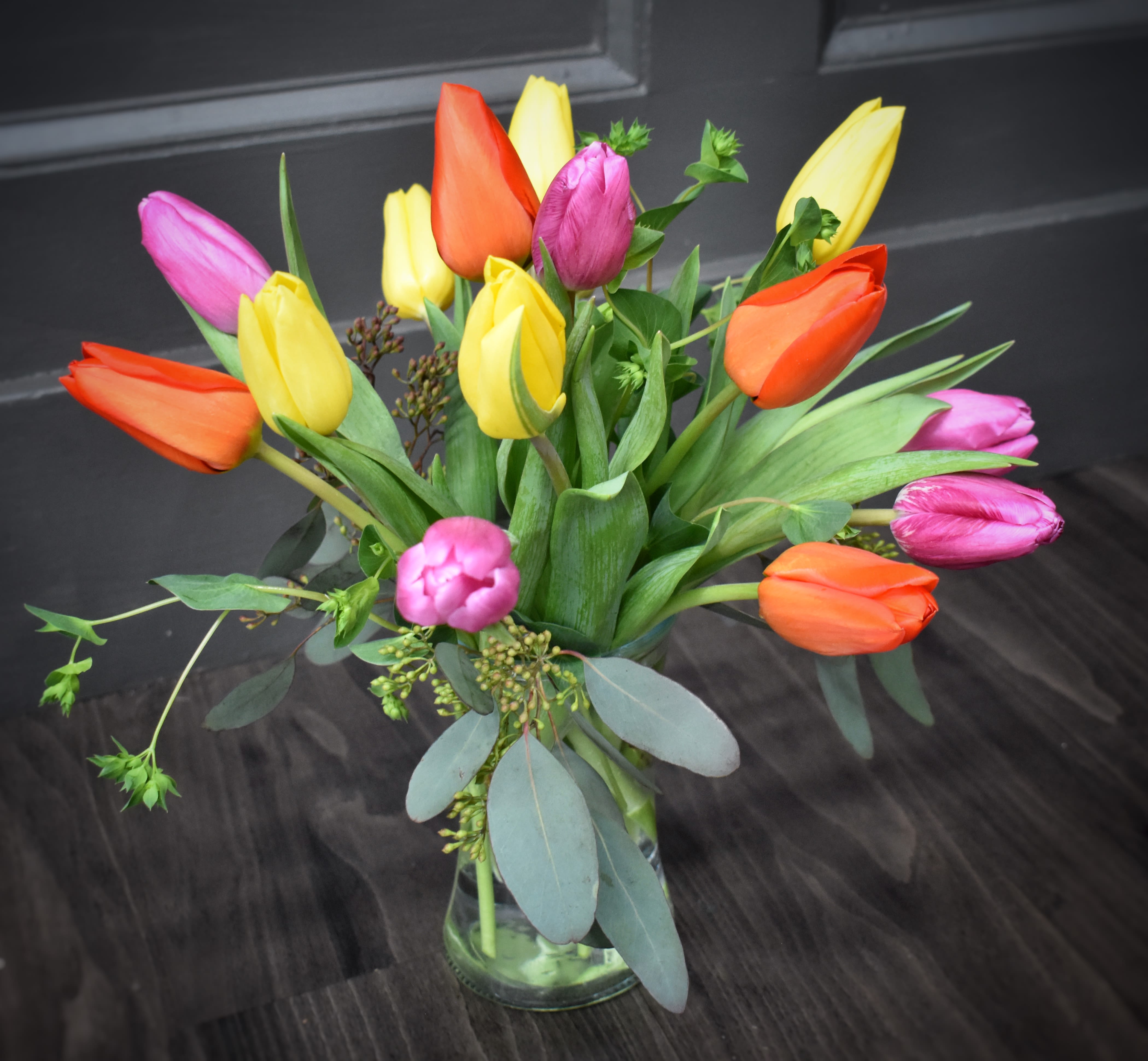 Rainbow Tulips - A brightly colored mixture of 15 tulips simply designed in a clear glass vase