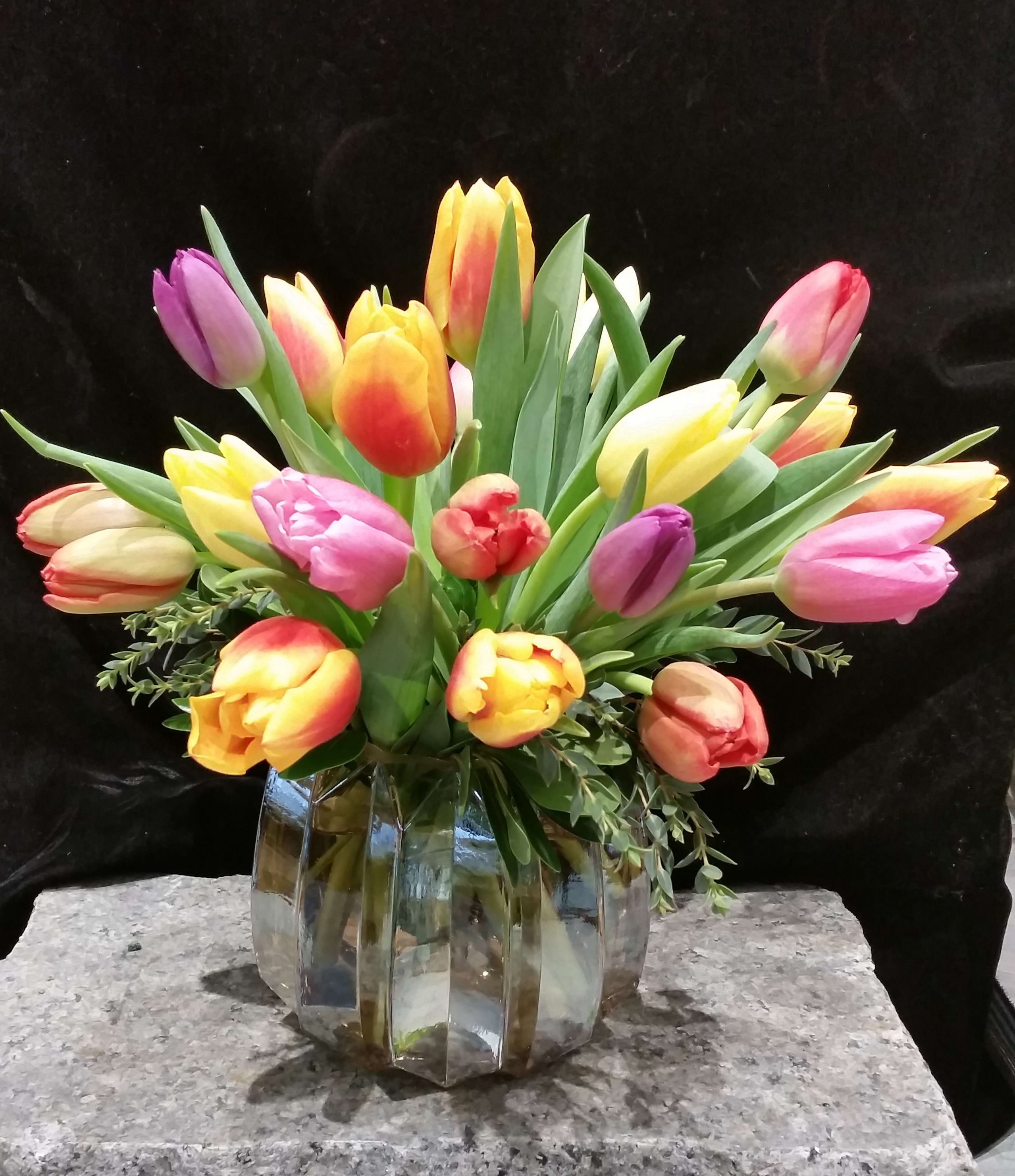 Super Select Tulips in Crystal Clear Vase - The name says it all.  We take two bunches of our best of the best Tulips and design a lovely swirl in a perfectly clear glass vase. Incredible color will bloom before you from these plump, beautiful tulips.  We guarantee it!  