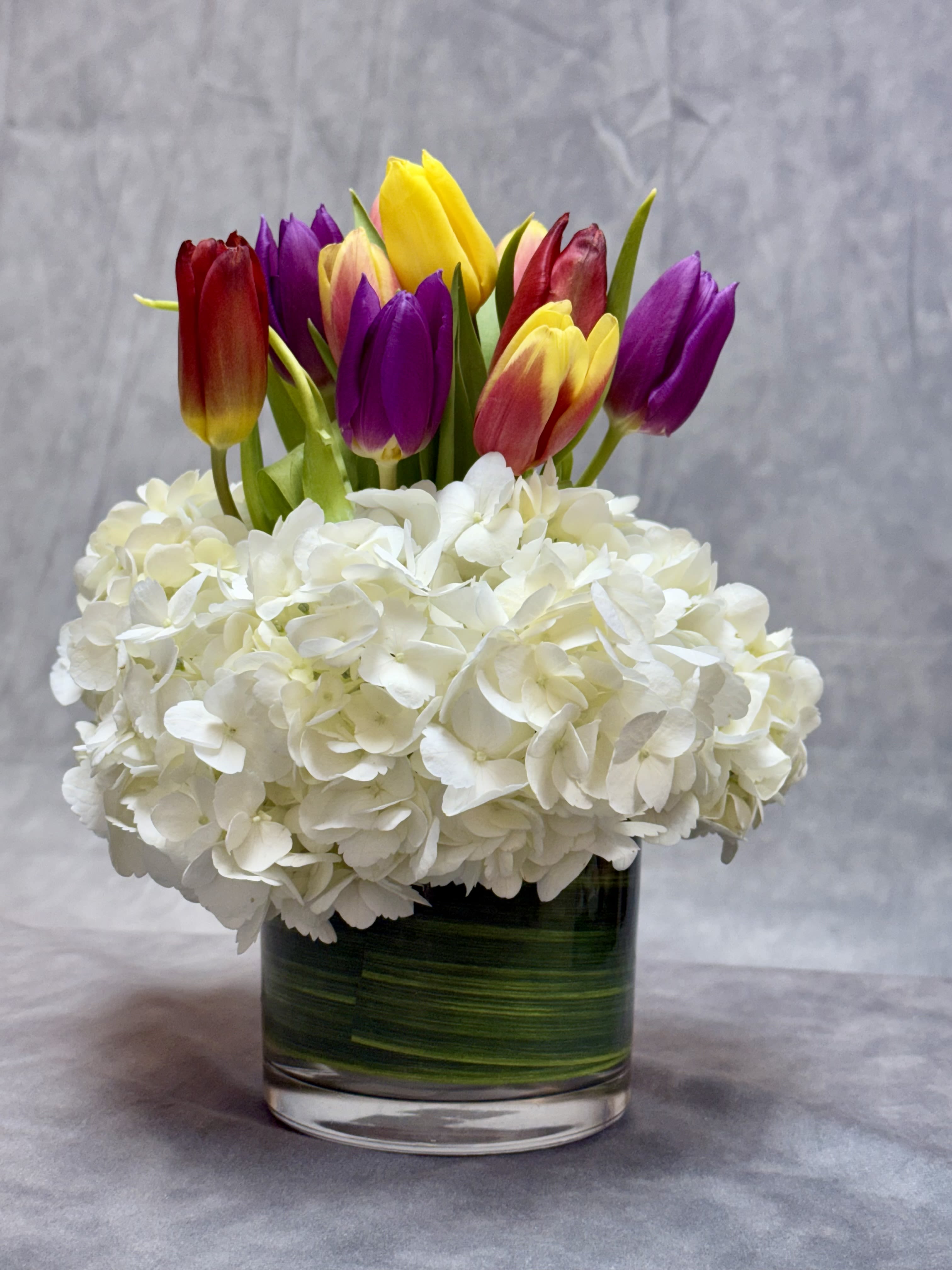 Tulips Kisses  - Say hello to Tulip Kisses  a delicate blend of tulips and hydrangeas, designed to bring a soft touch of love and elegance to any space. Perfect for sharing sweet moments and blooming smiles
