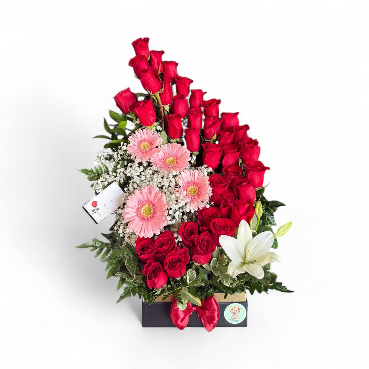 Rose Paradise - Rose paradise a delightful arrangement that captures the essence of a blooming garden. With vibrant roses, cheerful gerberas and elegant lilies. 