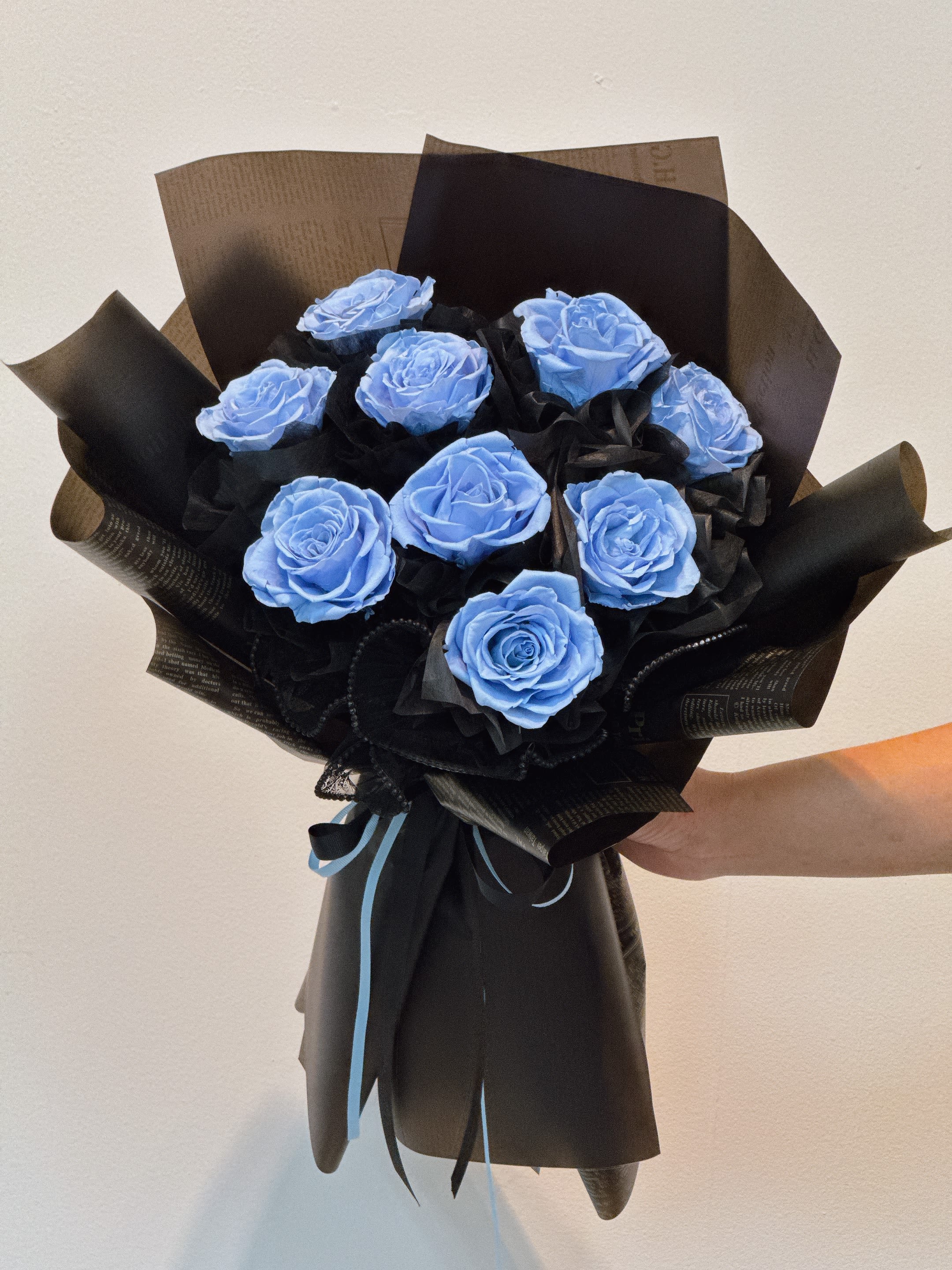 Midnight Ice - Bold. Calm. Timeless. Preserved blue roses wrapped in black for a modern, unforgettable statement  No water. No wilting. Just forever.