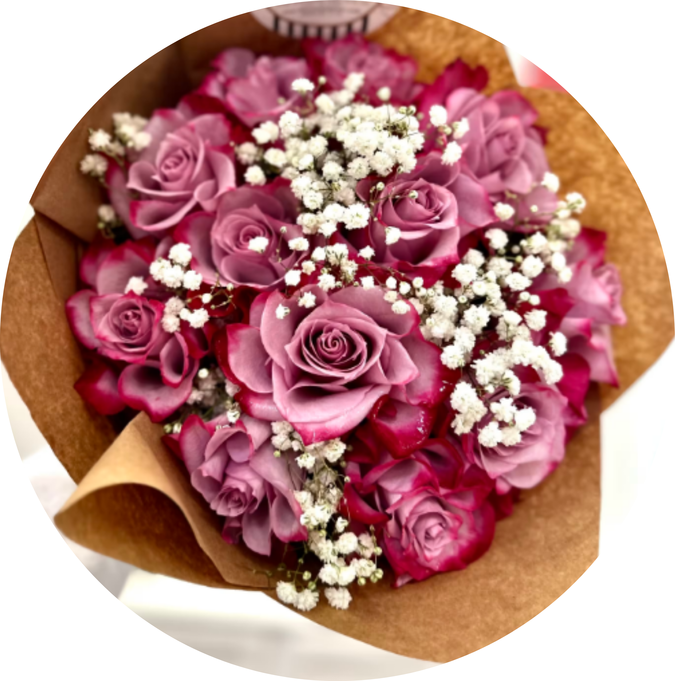 One Dozen Purple Roses Wrapping Bouquet - A dozen vibrant, purple roses adorned with delicate baby's breath and lush greenery.