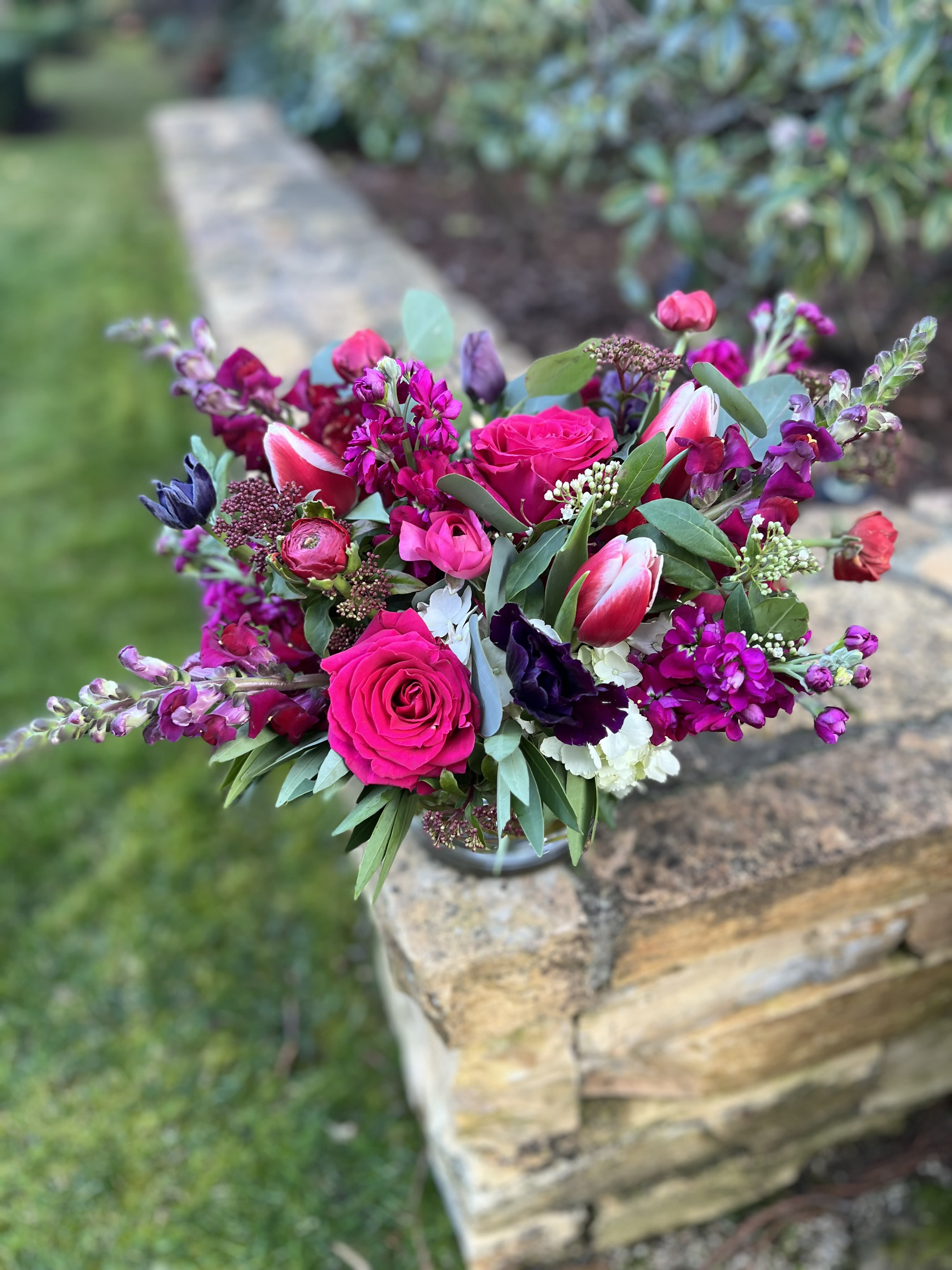 Falling in Fuschia  - A romantic mix of all shades pink, magenta, and purples with anemones, ranunculus, roses, and snapdragons. 