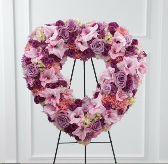 Eternal Rest Open Heart - The FTD® Eternal Rest™ Standing Heart bursts with love and sweet comfort to honor the deceased at their final farewell service. Lavender roses, pink carnations, purple button poms, lavender chrysanthemums, pink gladiolus and pink hydrangea are beautifully arranged in the shape of a heart and displayed on a wire easel to create a stunning display of warm affection that will last in the hearts of friends and family for years to come. Approximately 22-inches in diameter.