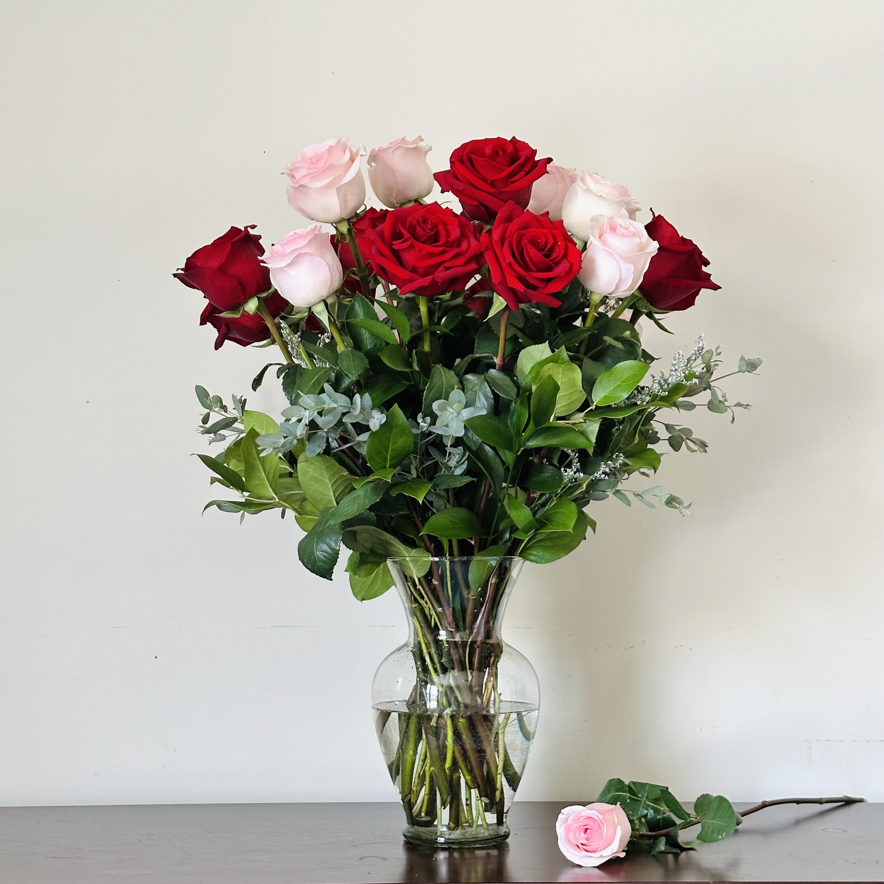 Romance  - Premium long stem Ecuadorian roses, hand-selected for their rich color, flawless petals, and lasting beauty. A timeless expression of love and elegance. Red and Pink Roses Standard includes 12 Roses and 24 for Deluxe  