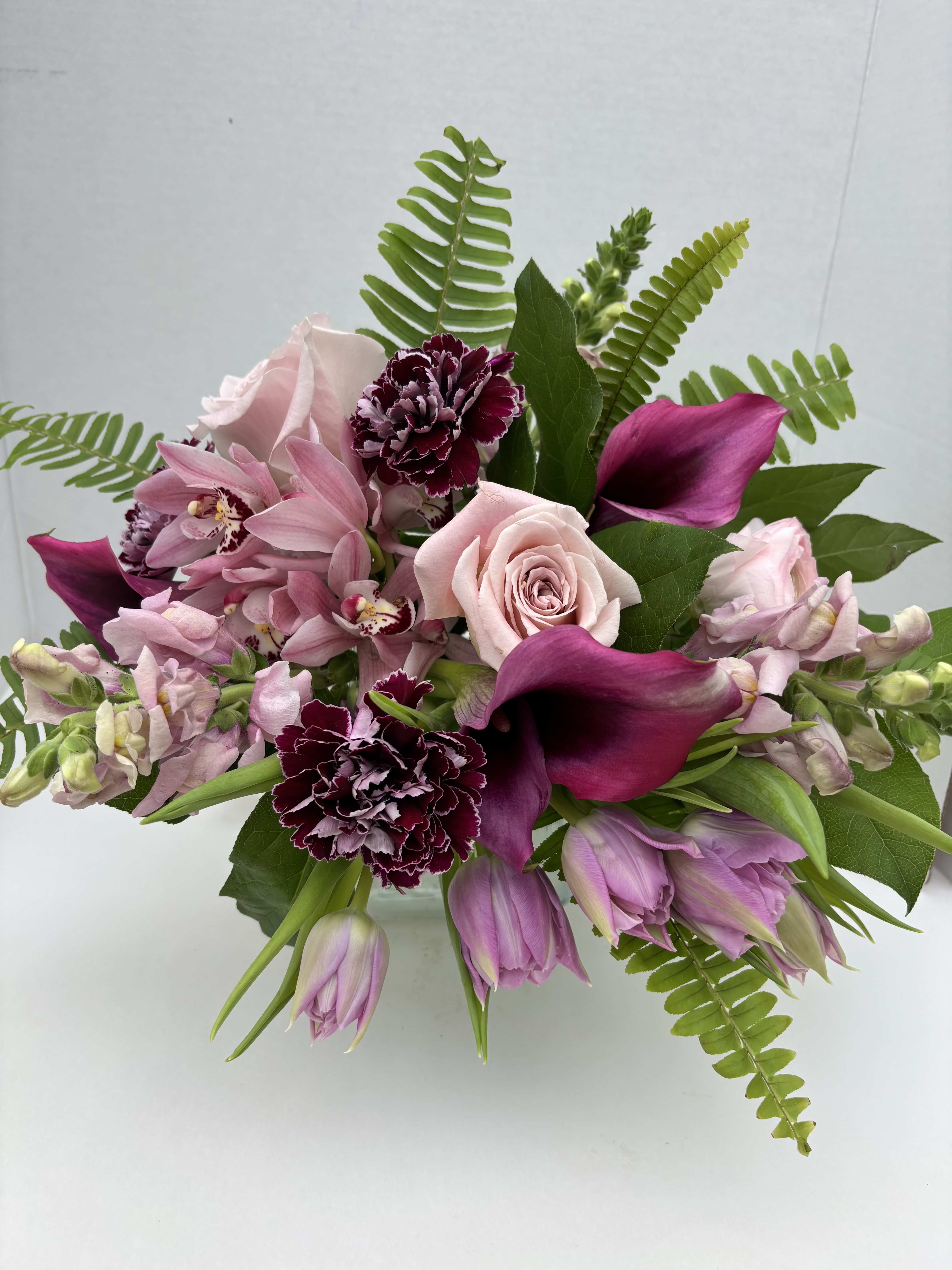 lavender sensation - Touches of elegant lavender and soft pink blooms arranged in a low clear vase. Perfect for any occassion. 