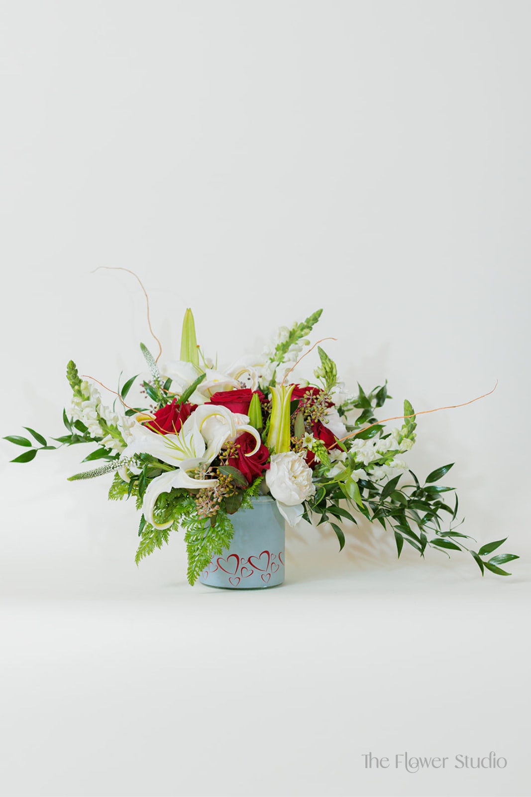 Heartbeat - Classic, elegant, and full of grace, this timeless arrangement combines the beauty of rich red and pure white blooms. Perfect for any occasion, this arrangement exudes elegance, making it a beautiful expression of love and beauty Approx. H15” x W26” 