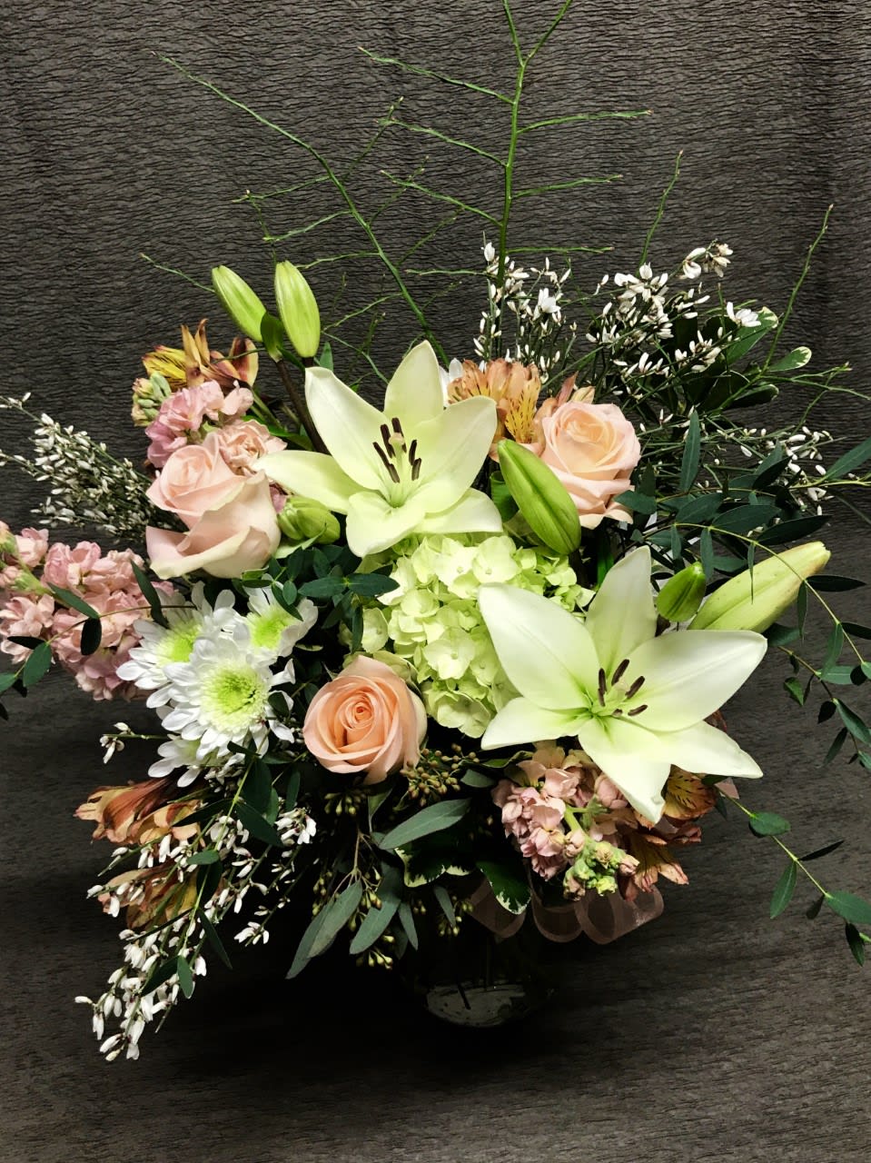 Wintry Mixed Bouquet - Winter mixed bouquet of seasonal flowers and roses.  Colors may vary. Be sure to order in advance. Premium filler flowers and greenery. Nicely defined.  Lovely anniversary flowers