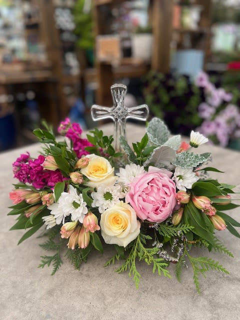 Graceful Blooms - A gentle and comforting arrangement with soft pastel blooms and fresh greenery, designed around a glass cross as a symbol of peace and remembrance. Perfect for expressing love, faith, and sympathy during times of loss.