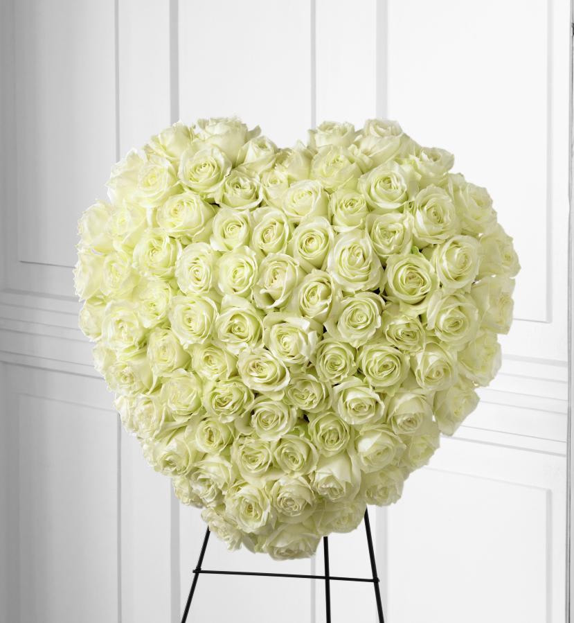 FTD Elegant Remembrance Standing Heart - The FTD Elegant Remembrance Standing Heart is an exquisite  display of peace and love.  77 stems of white roses are artfully  arranged in the shape of a heart and presented on a wire easel, creating  a simply beautiful tribute for their final farewell service.  24""h x 22""w "