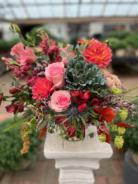 Wild Radiance - A vibrant and lively arrangement with bold pinks, reds, and corals, balanced by textured greenery and deep accents for a striking, garden-fresh look.