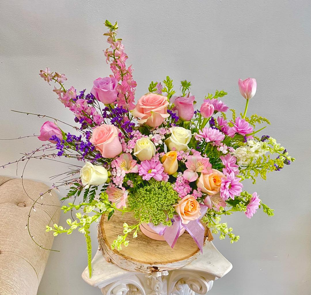 Bright Horizon  - Theme Colors: Shades of blue, yellow and white  Featured Blooms: Roses, tulips, larkspur, green mist, static, Alstroemeria,   and wild greenery.  HK Flowers have a uniqueness of florals and seasonal blooms, certain flowers or colors may not be available as each season affects the availability, color, size, and shape of each floral bloom. Some flowers may be substituted accordingly.  Photos are used as a reference for the color palette and is NOT indicated of the final product. We ask for your trust in us that we will pick out the best seasonal available blooms, while still capturing the arrangements' theme and colors mentioned above.