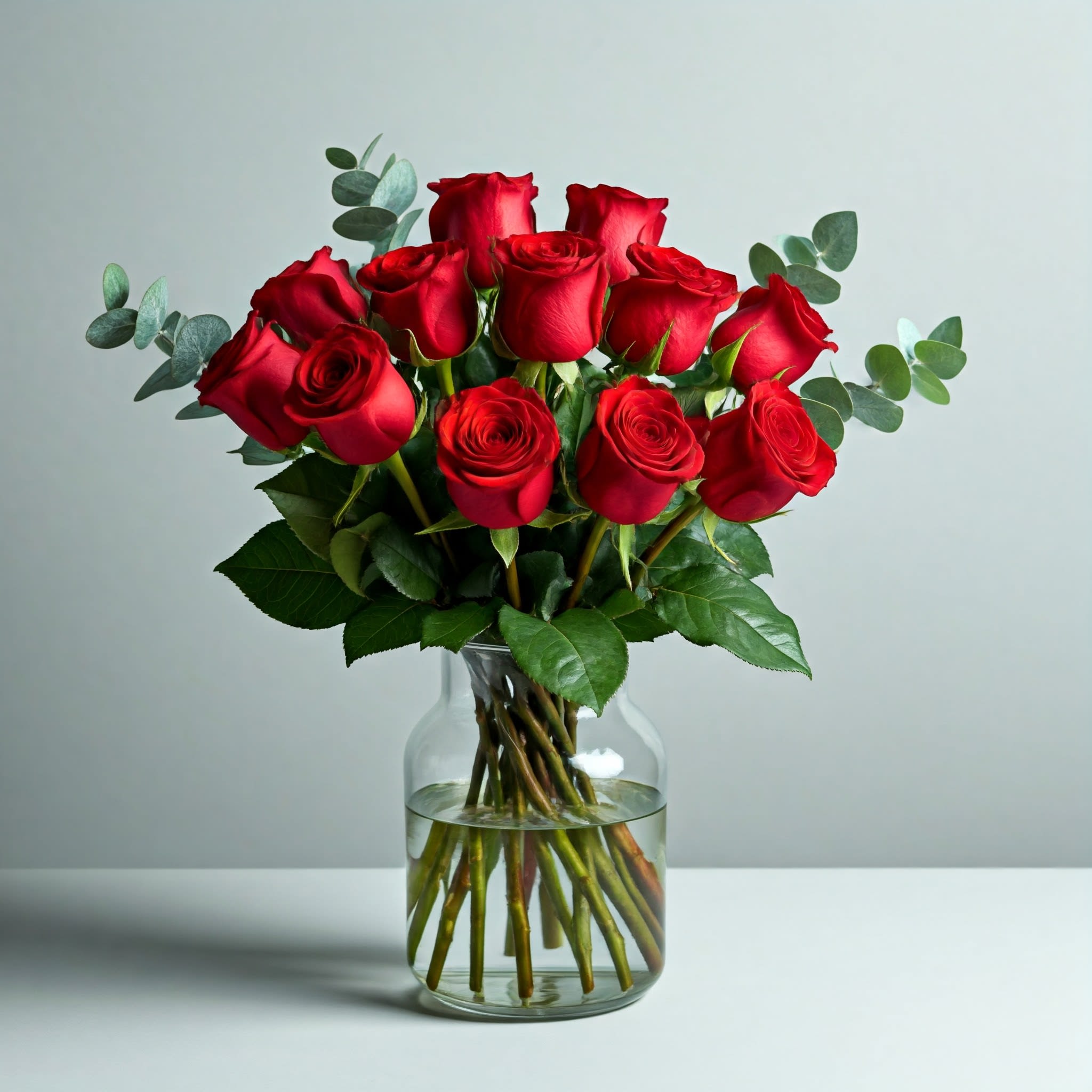 Timeless Romance Red Roses - Timeless Romance Red Roses  Express your deepest affection with a classic bouquet of twelve long-stemmed red roses. This timeless symbol of love is the perfect way to celebrate Valentine’s Day, an anniversary, or any special occasion. Each velvety rose is a testament to your passion and devotion.  Our expert florists carefully select and arrange these exquisite blooms to create a stunning centerpiece that will leave a lasting impression. Whether you choose to surprise your loved one or celebrate your enduring bond, this elegant arrangement is a heartfelt expression of your love.  Standard - 12 Red Roses Deluxe - 24 Red Roses Premium - 36 Red Roses