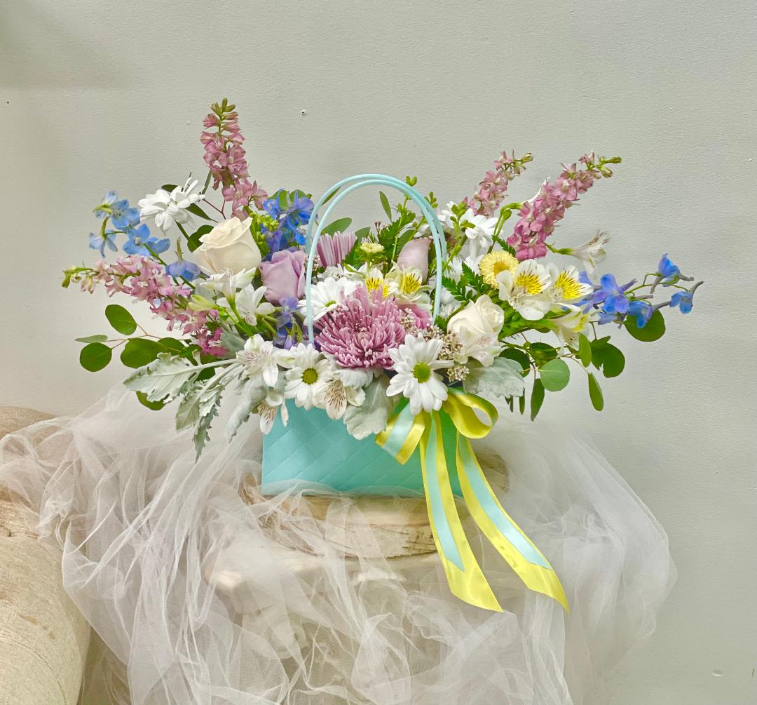 Ocean reflection -  Theme Colors: Shades of blue, yellow and purple.  Featured Blooms: Roses, larkspur, Chrysanthemums, Alstroemeria, Delphinium, and greenery.  HK Flowers have a uniqueness of florals and seasonal blooms, certain flowers or colors may not be available as each season affects the availability, color, size, and shape of each floral bloom. Some flowers may be substituted accordingly.  Photos are used as a reference for the color palette and is NOT indicated of the final product. We ask for your trust in us that we will pick out the best seasonal available blooms, while still capturing the arrangements' theme and colors mentioned above.