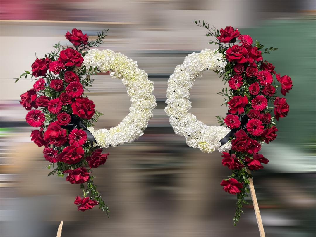 Red &amp; White Funeral Wreath| Large - Theme Colors: Shades of red, white and green  Featured Blooms: Roses, Hydrangea Gerbera and greens.  HK Flowers have a uniqueness of florals and seasonal blooms, certain flowers or colors may not be available as each season affects the availability, color, size, and shape of each floral bloom. Some flowers may be substituted accordingly.  Photos are used as a reference for the color palette and is NOT indicated of the final product. We ask for your trust in us that we will pick out the best seasonal available blooms, while still capturing the arrangements theme and colors mentioned above.