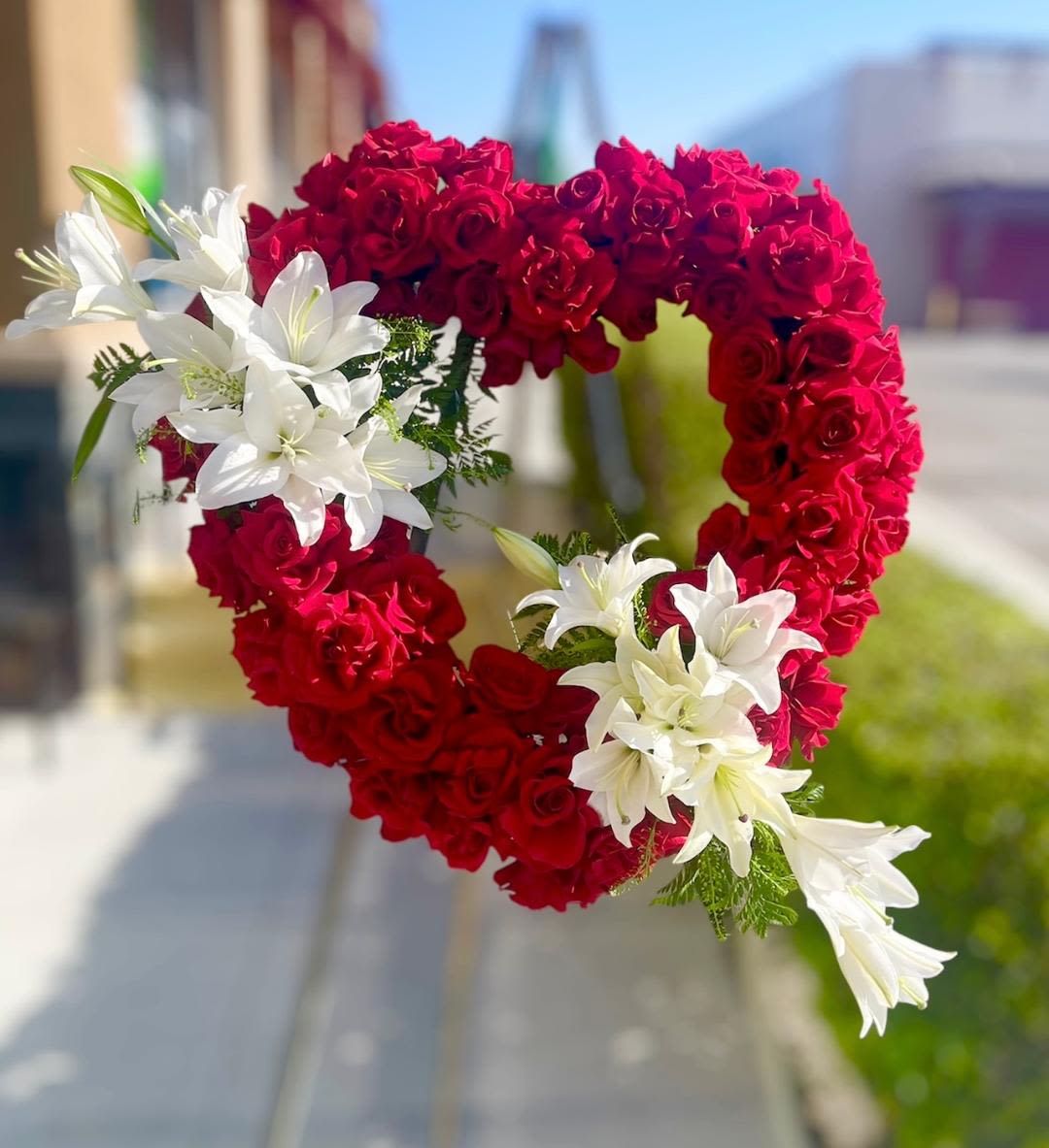 Red heart funeral - Theme Colors: Shades of white and red  Featured Blooms: Roses and lilies.  HK Flowers have a uniqueness of florals and seasonal blooms, certain flowers or colors may not be available as each season affects the availability, color, size, and shape of each floral bloom. Some flowers may be substituted accordingly.  Photos are used as a reference for the color palette and is NOT indicated of the final product. We ask for your trust in us that we will pick out the best seasonal available blooms, while still capturing the arrangements theme and colors mentioned above.