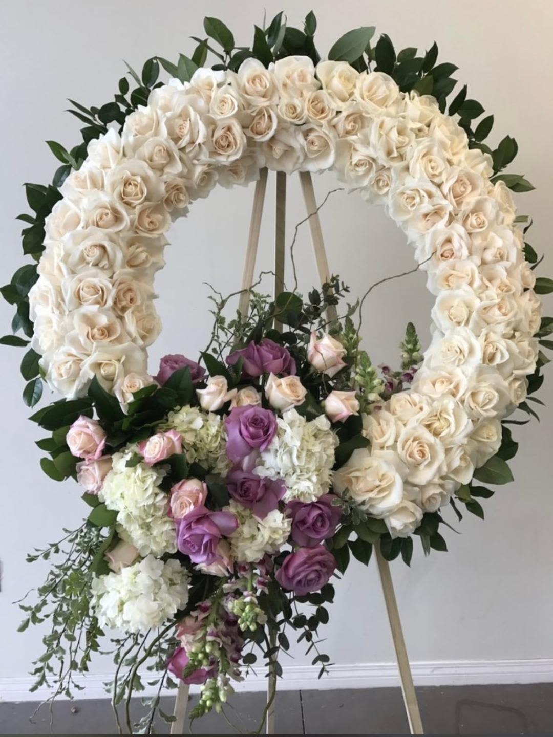 Round funeral standing flowers - Theme Colors: Shades of white and green.  Featured Blooms: Roses, Hydrangeas, and greens  HK Flowers have a uniqueness of florals and seasonal blooms, certain flowers or colors may not be available as each season affects the availability, color, size, and shape of each floral bloom. Some flowers may be substituted accordingly. Funeral standing flowers.  Photos are used as a reference for the color palette and is NOT indicated of the final product. We ask for your trust in us that we will pick out the best seasonal available blooms, while still capturing the arrangements theme and colors mentioned above.