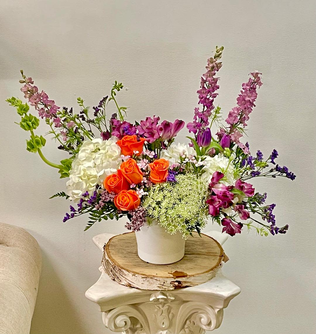 Sumatra - Product Information   Theme Colors: Shades of pinks  Featured Blooms: Roses, Hydrangeas, Alstroemeria, Delphinium, wild greenery, Seasonal Blooms in the white vase  HK Flowers have a uniqueness of florals and seasonal blooms, certain flowers or colors may not be available as each season affects the availability, color, size, and shape of each floral bloom. Some flowers may be substituted accordingly.  Photos are used as a reference for the color palette and is NOT indicated of the final product. We ask for your trust in us that we will pick out the best seasonal available blooms, while still capturing the arrangements' theme and colors mentioned above.